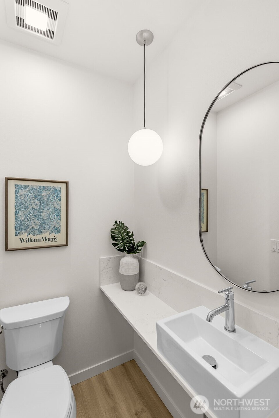 Powder room with refined finishes and polished fixtures adds convenience.