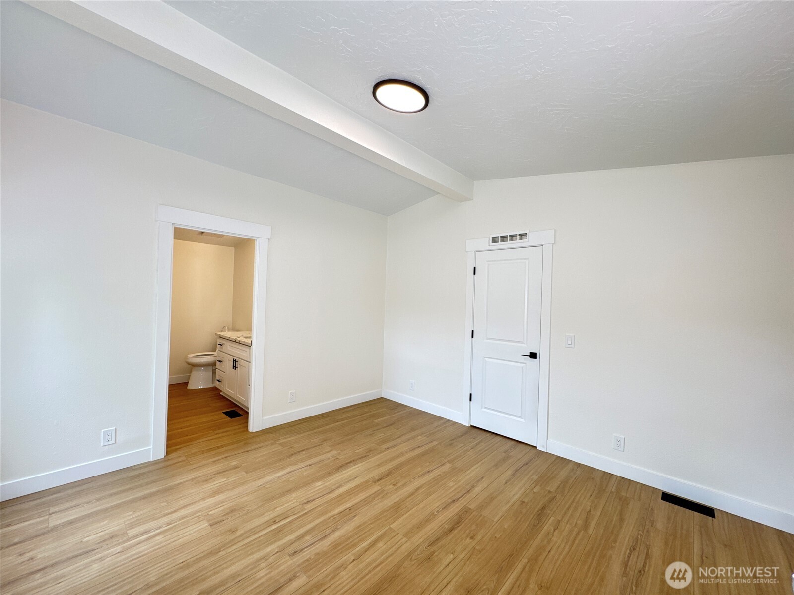 Primary bedroom, connected to primary bathroom.