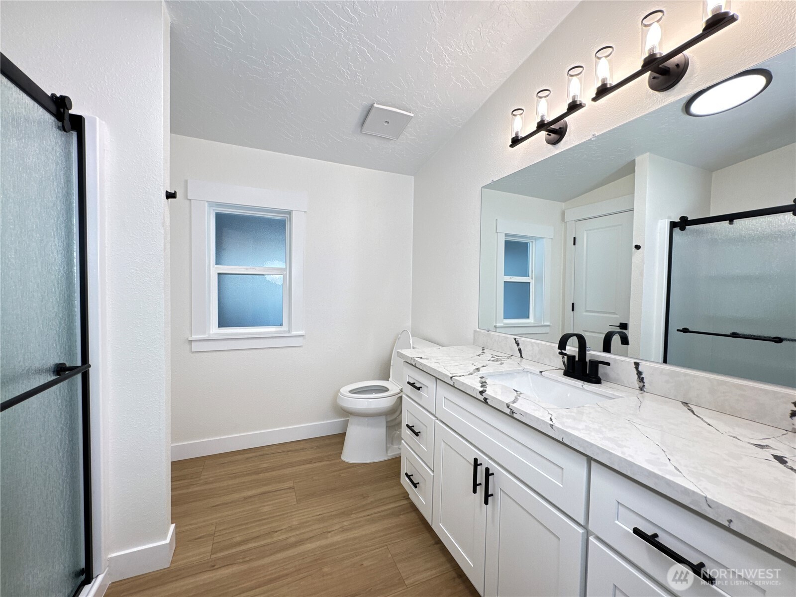 Primary bathroom. Brand new, just installed cabinet, quartz countertop, sink, faucet, toilet, doors, flooring.