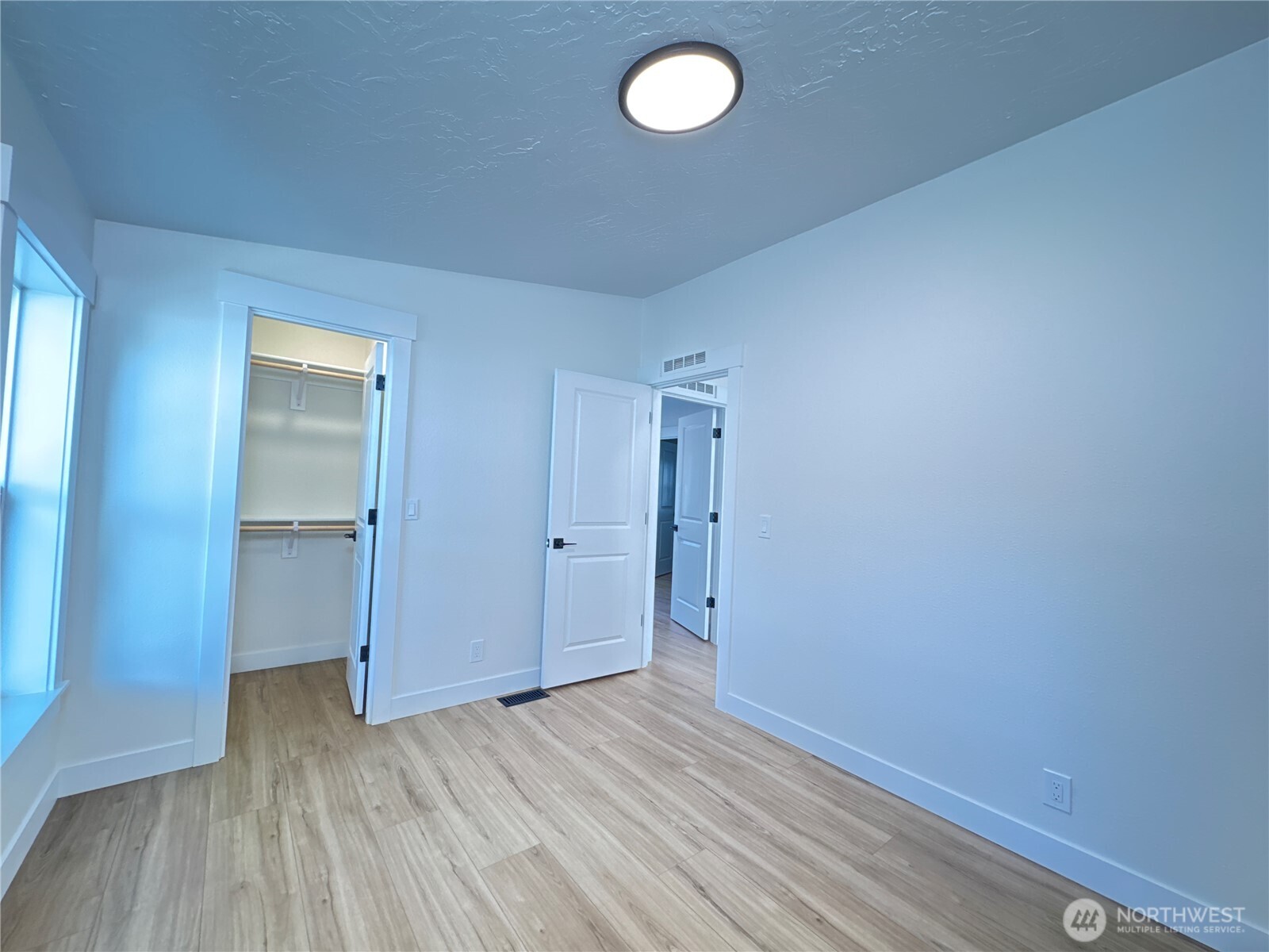 Secondary bedroom. All new floors, new windows, new light fixture, new closet kit, freshly painted.