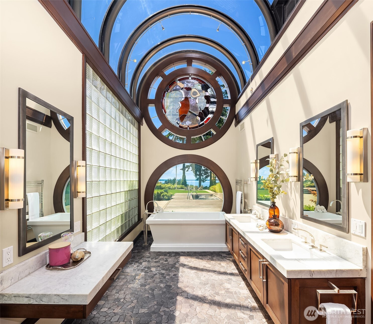 Spa inspired primary bathroom with privacy glass a the touch of a button. Heated stone floors.