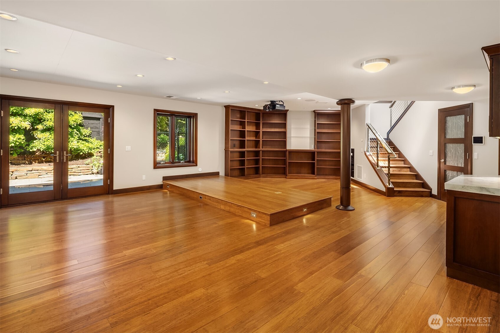 Lower level great room with built in library style shelving