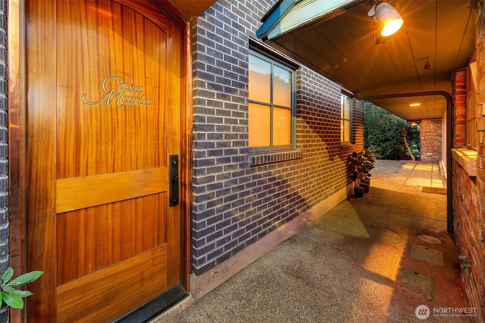 A handcrafted solid-cedar entry door anchors the bungalow’s private approach along the south side of the Fairway residence. Its generous width and weight signal the level of craftsmanship throughout, creating a quiet, independent point of arrival separate from the main home.