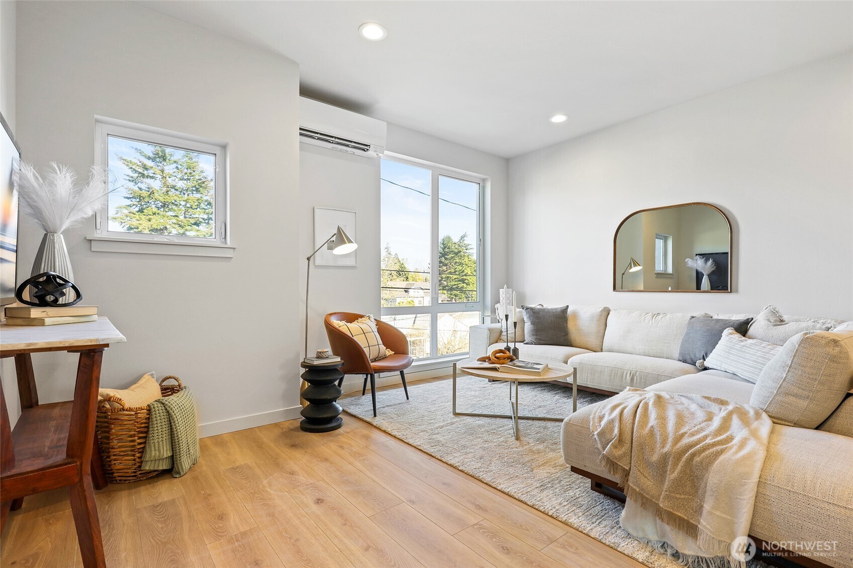 Let the natural light pour in. This airy living room has warm tones, soft textures, and modern edges.
