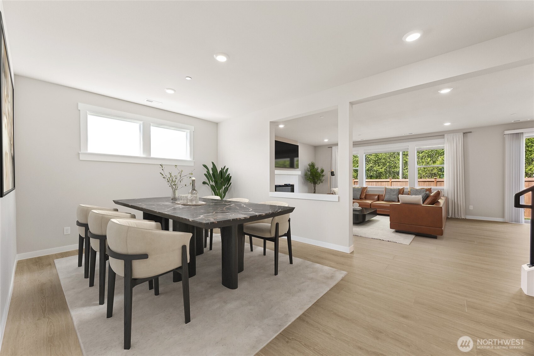 Formal dining adjacent to the great room, virtually staged.
