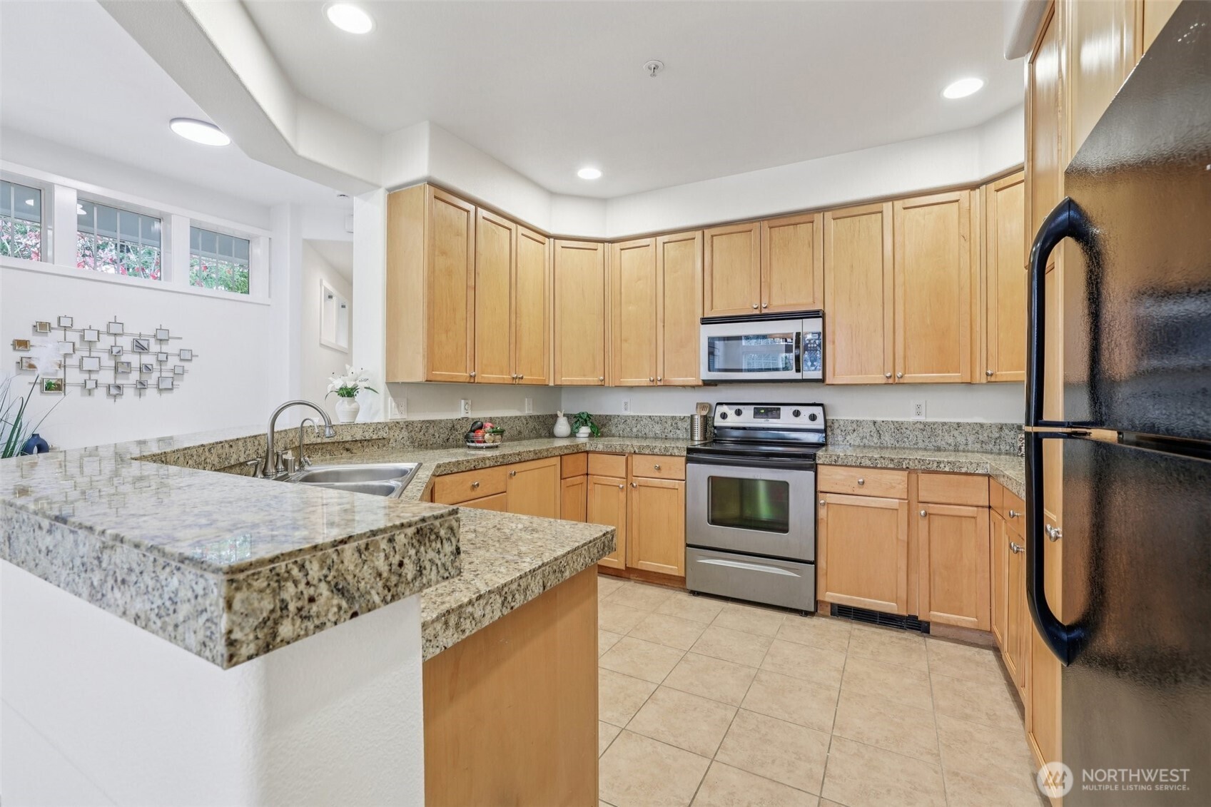 Exceptional kitchen layout with tile floors, granite countertops and loads of cabinetry!