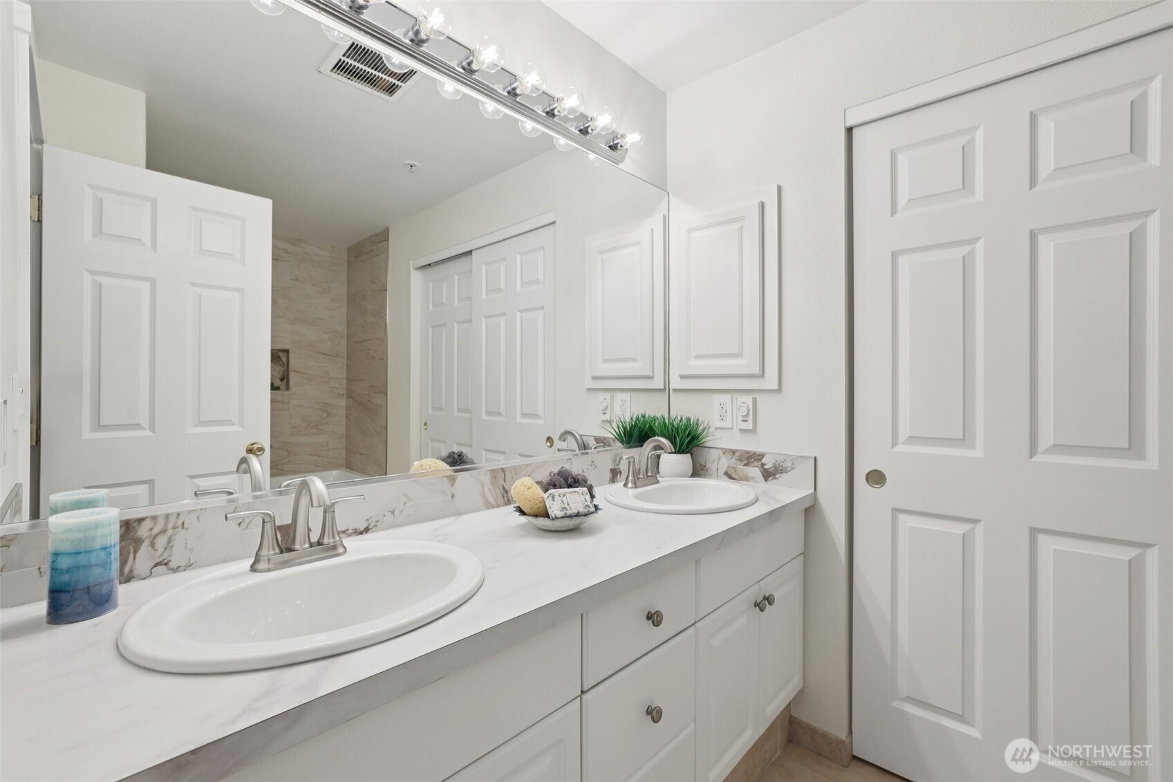 Dual sink vanity with door to walk in closet