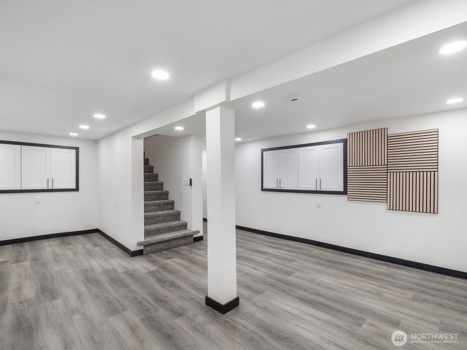 Another view of the fully finished basement with built in cabinetry