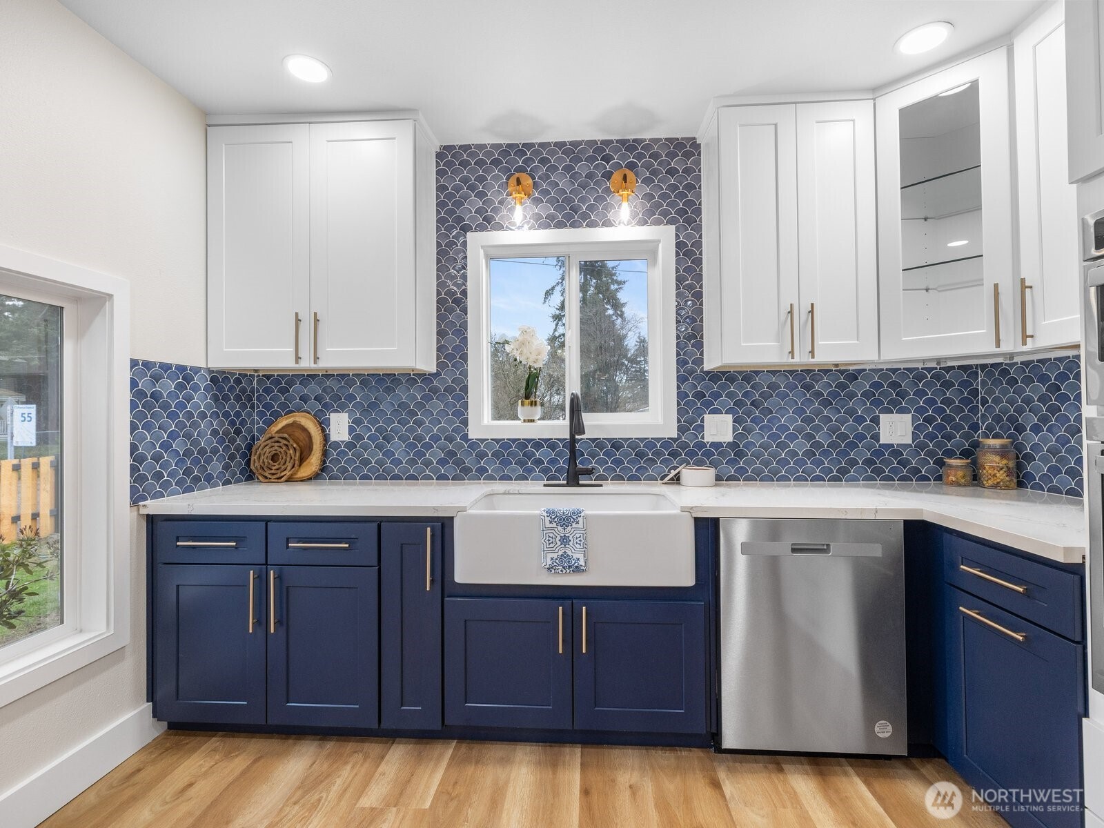 Custom tile backsplash, slide out spice rack, lazy susan, and slide outs for the garbage and recycling make this kitchen super functional