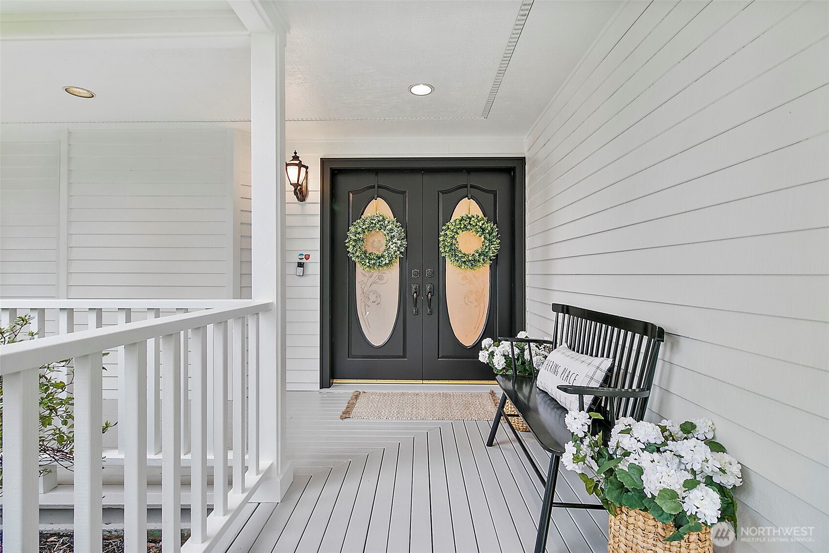 Wrap around porch with grand doors.