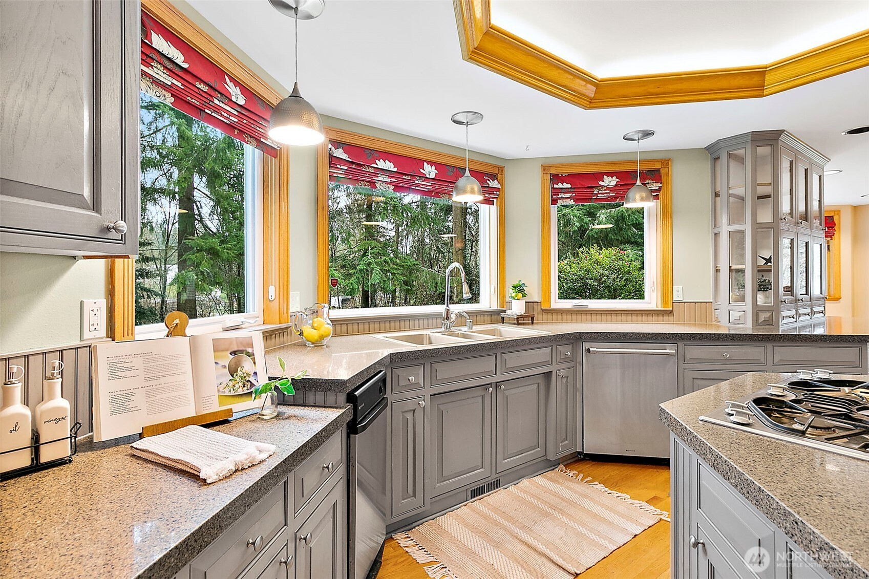 Kitchen window viewing backyard green space.