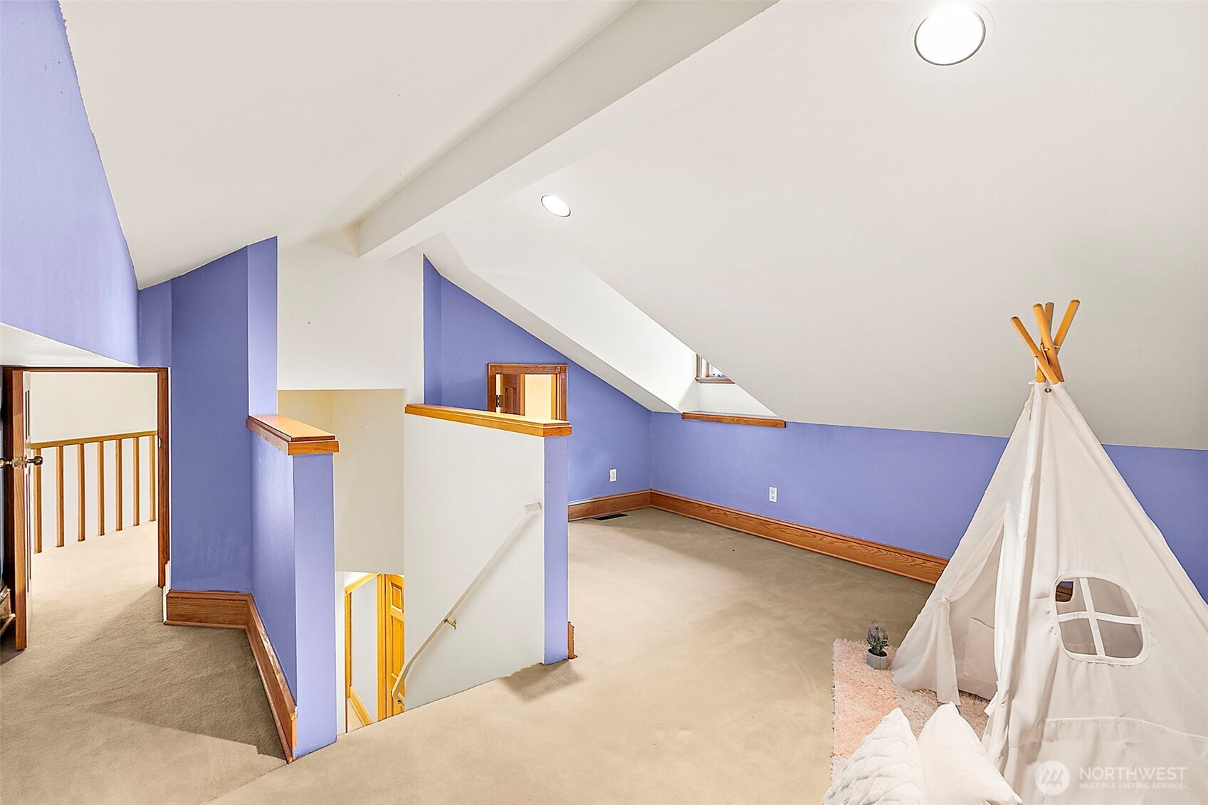 Loft space with two small doors leading to balcony's.