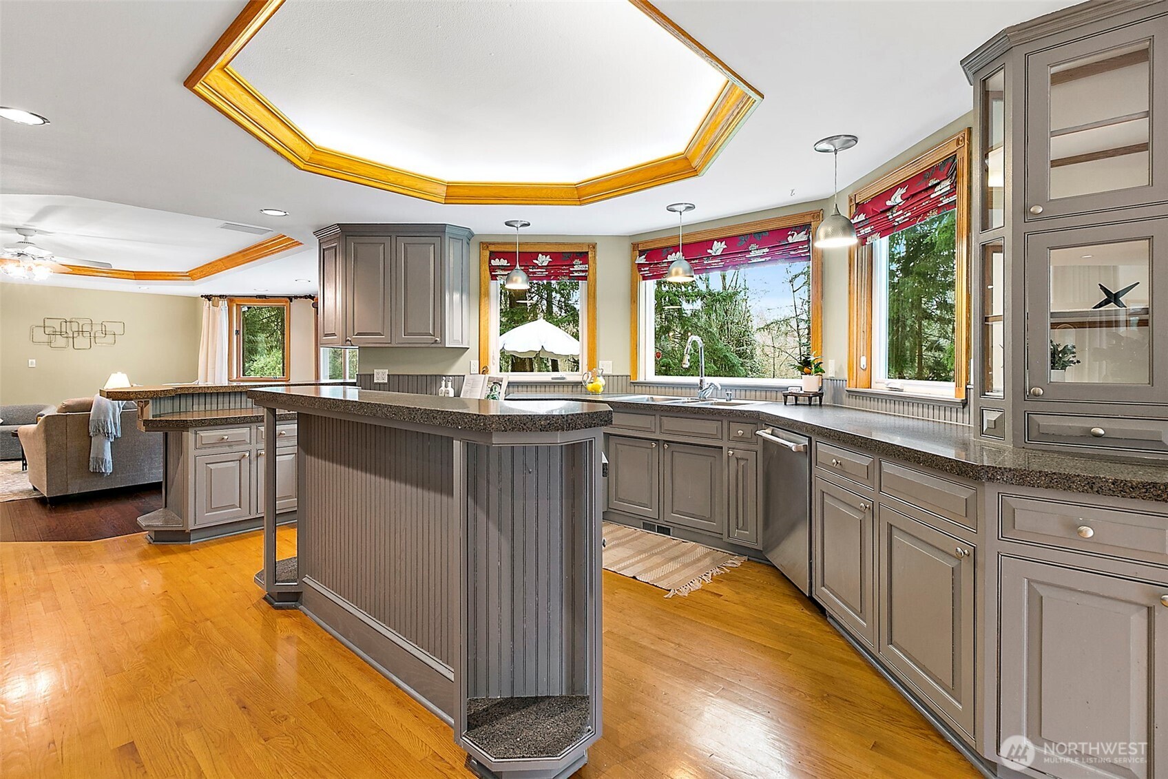 Kitchen with island and glass cabinets.