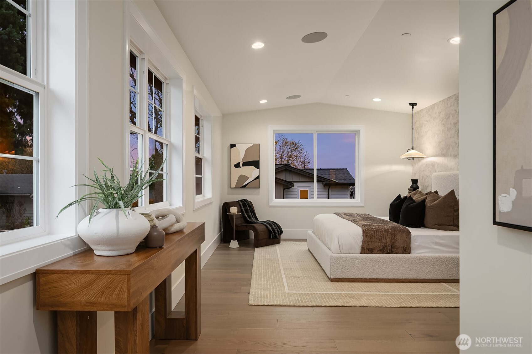 Spacious primary bedroom featuring generous proportions, Sonos speakers, and abundant windows that fill the room with natural light.