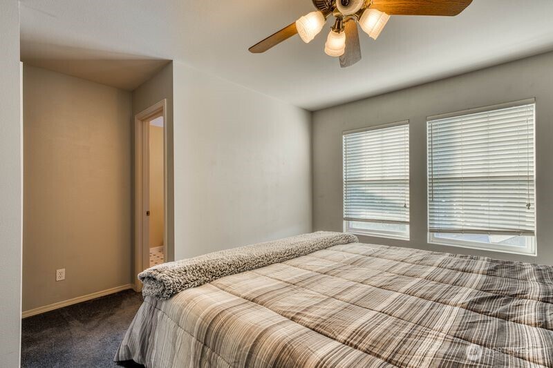 Primary looking at full bath on the right with walk-in closet directly across.