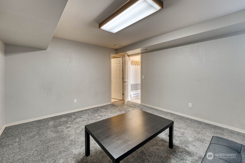 Lower level Bonus room access to both the garage on the right and large storage room to the left.