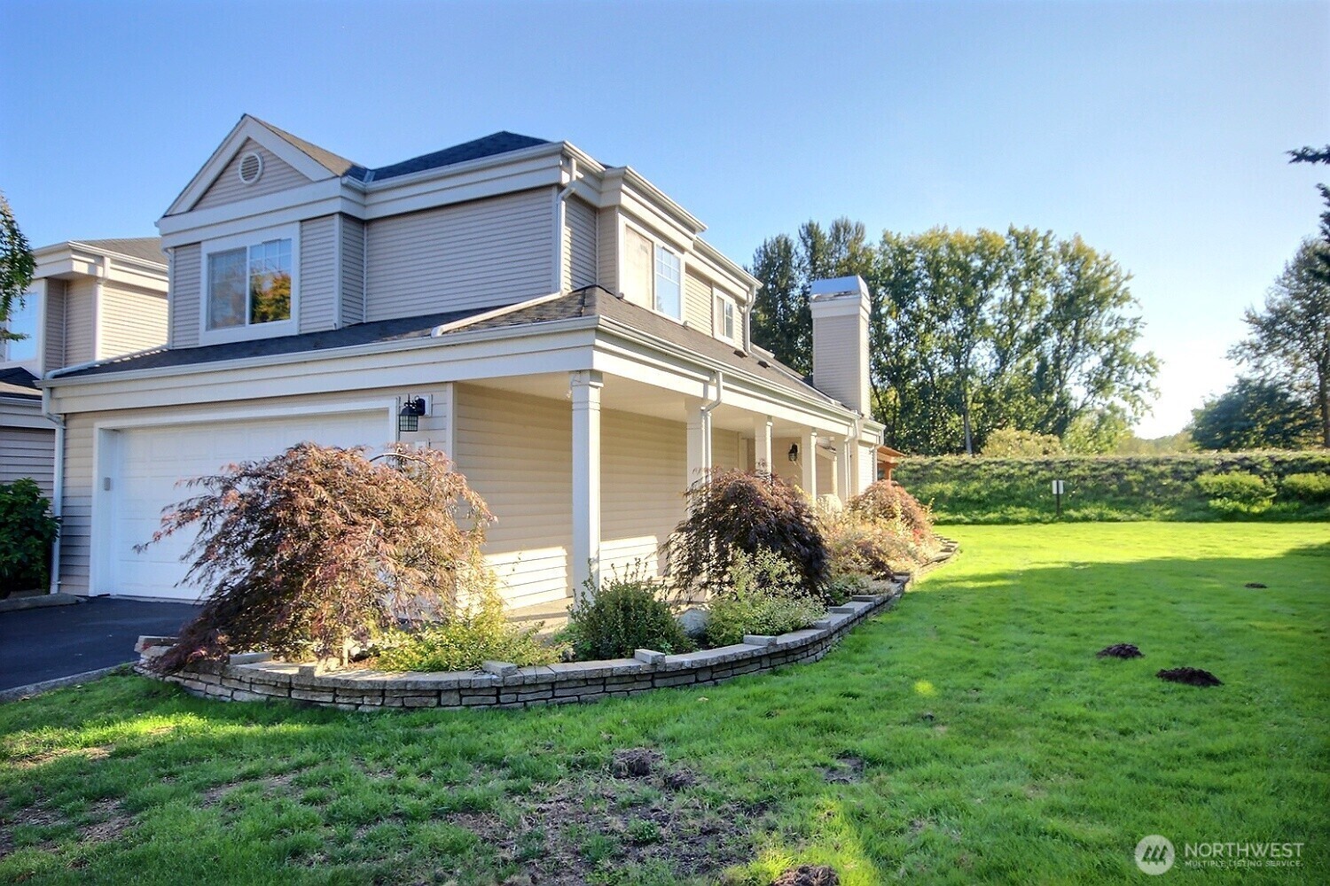 This end-unit townhome features a coverd walkway boardered by a professionaly landscaped garden.