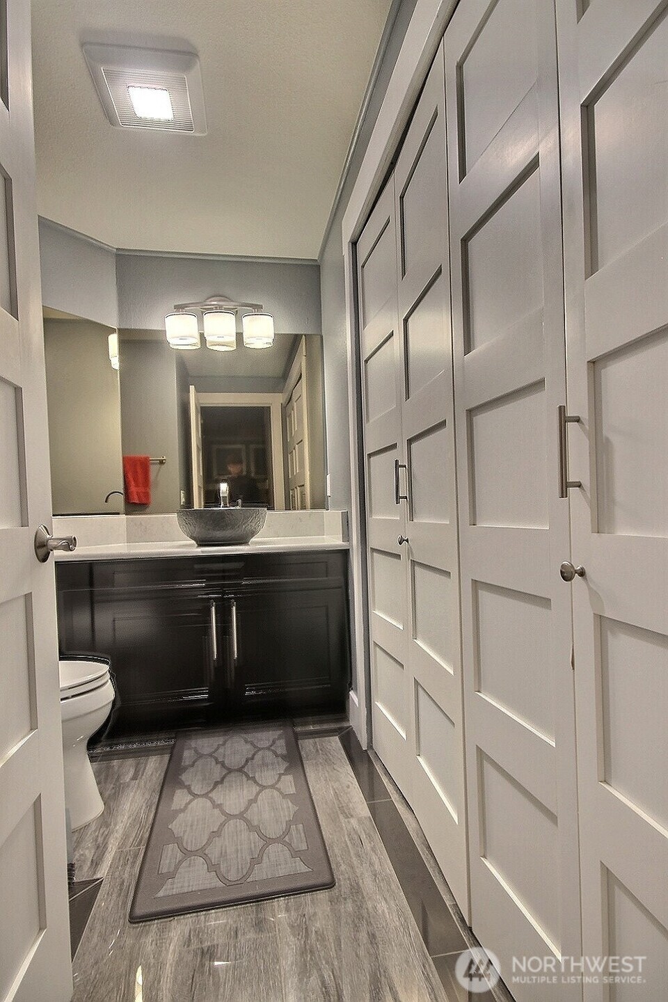 Downstairs, you’ll find a practical half bath with an in-unit washer and dryer, leading directly to a spacious two-car garage equipped with wall-mounted storage for all your organizational needs