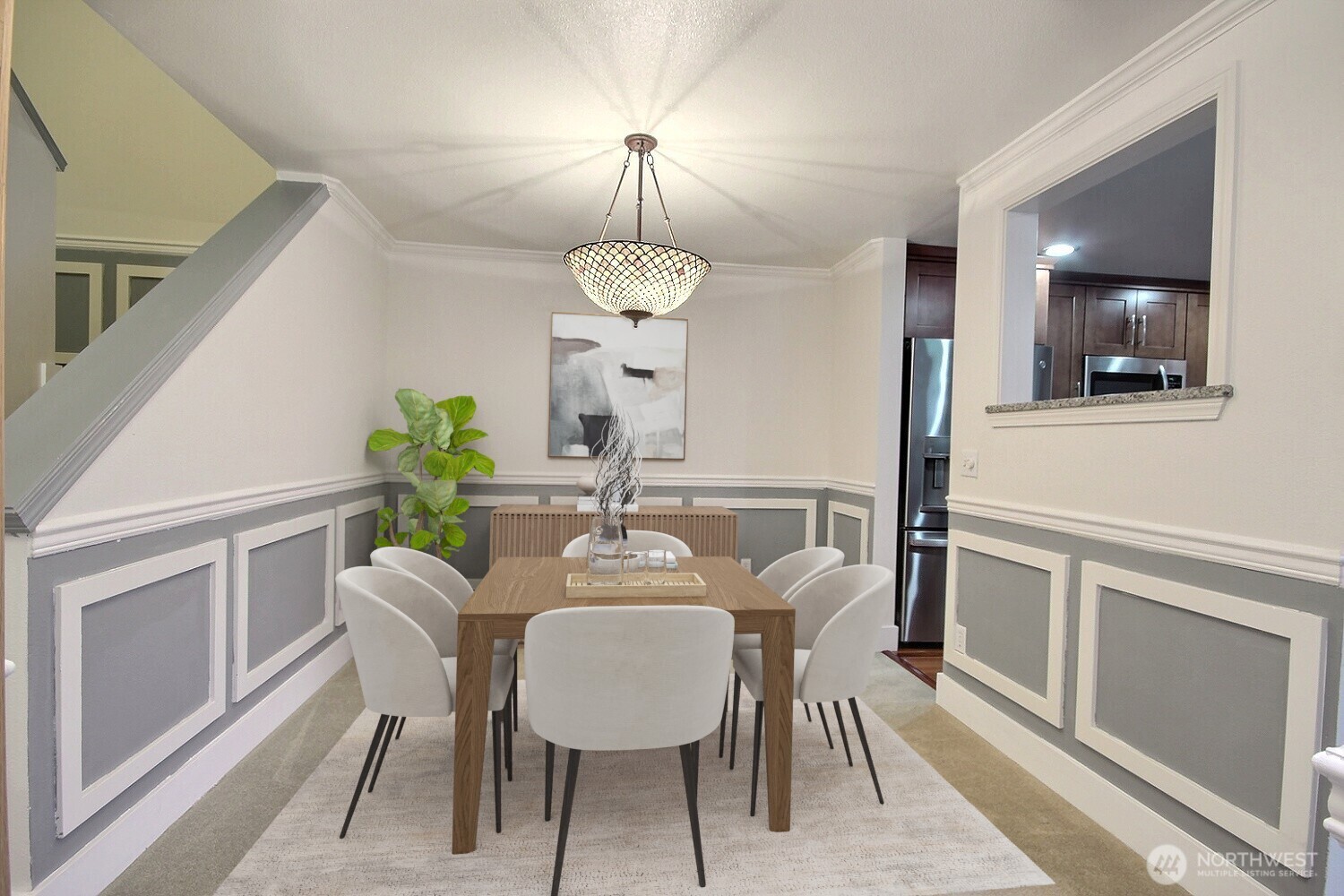 The refined dining room is distinguished by wainscoting on the walls and an impressive stained-glass chandelier, creating an atmosphere that reflects the unique character of the home.
