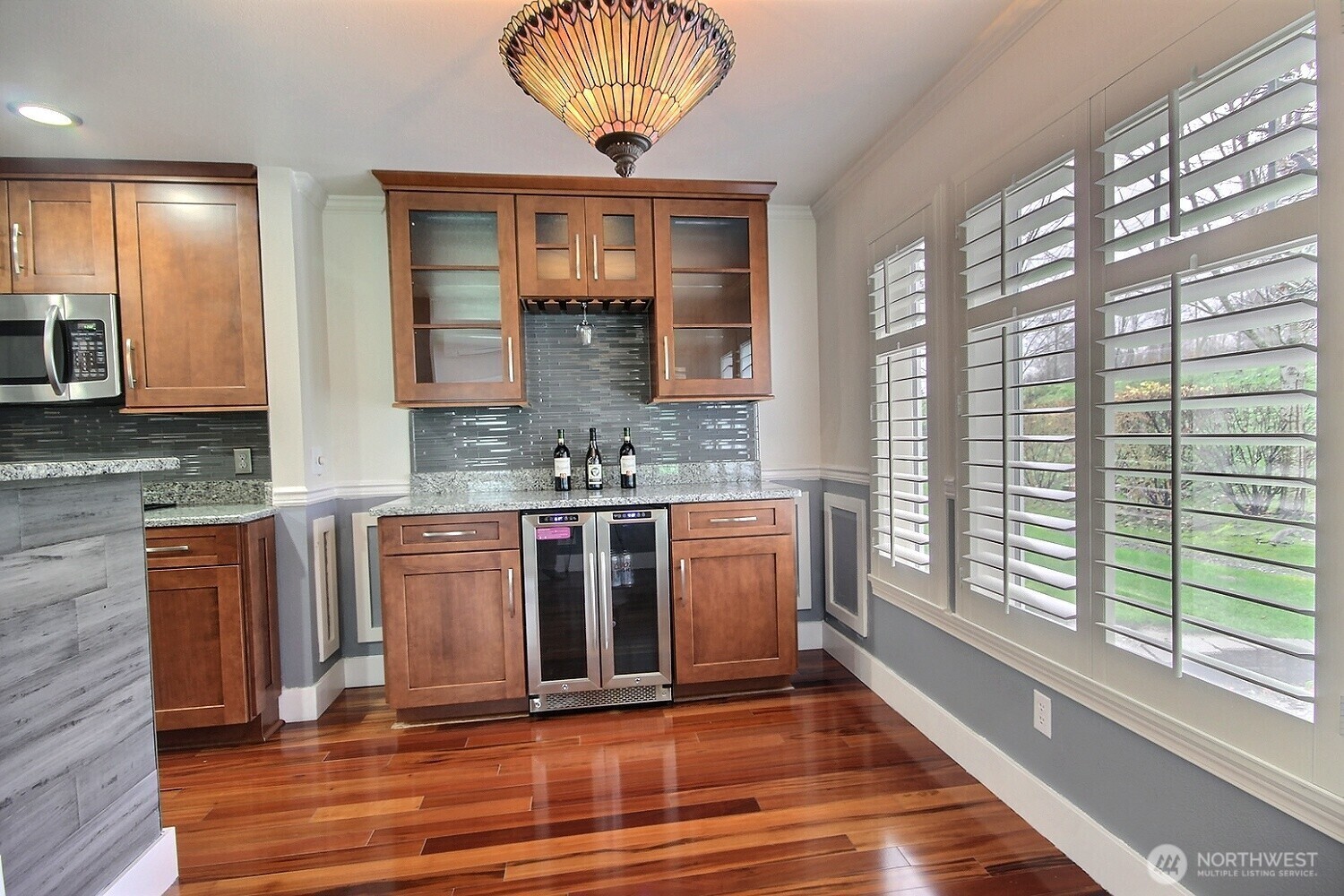 The breakfast nook includes a convenient beverage fridge—ideal for keeping drinks chilled for guests....
