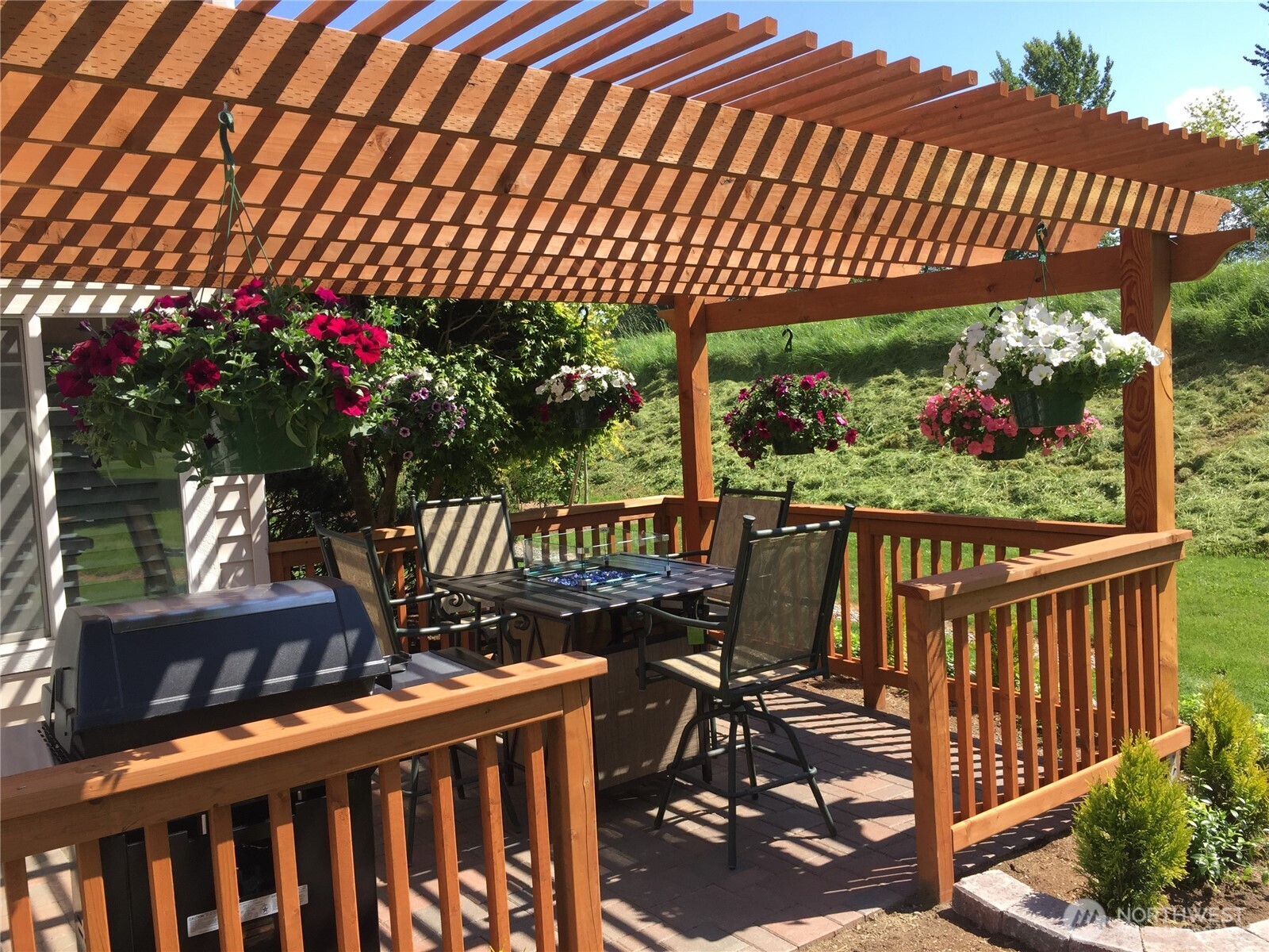 ..as you entertain guests enjoying the backyard fire pit beneath the charming pergola.