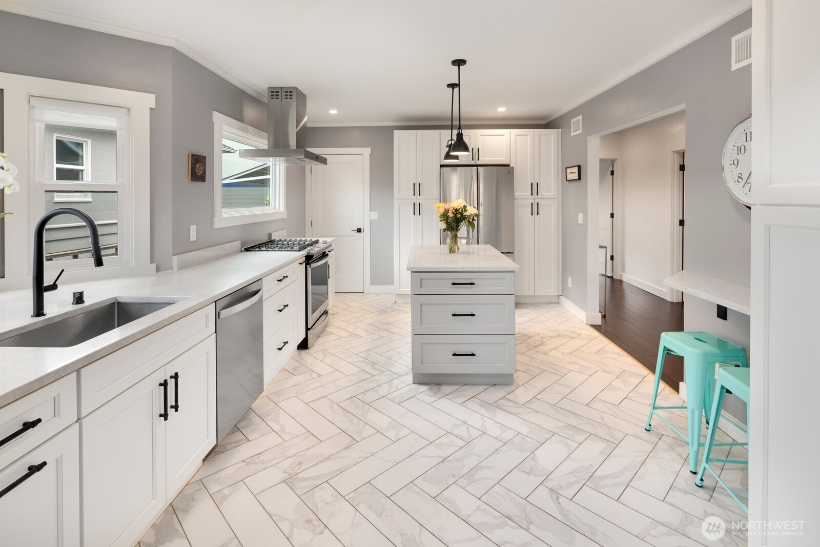 Stunning chef’s kitchen with custom shaker cabinetry, herringbone tile, and premium appliances—perfect for both everyday living and effortless entertaining.