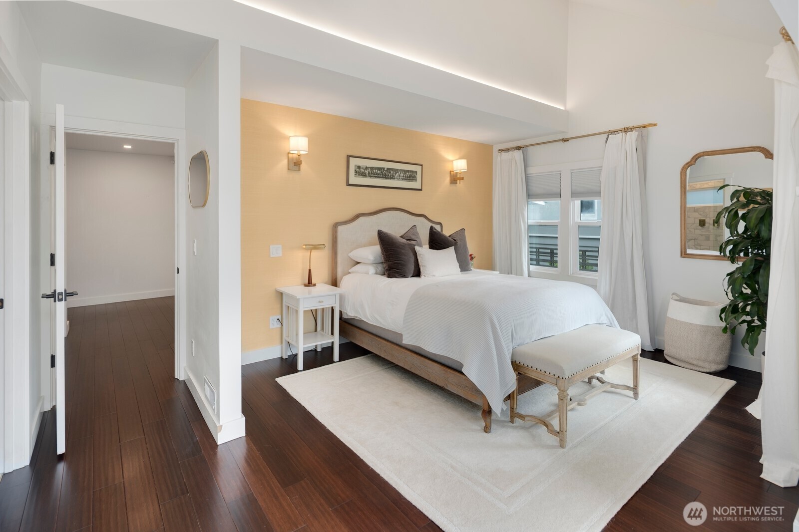 The main level primary suite is a true retreat, offering vaulted ceilings, a luxurious ensuite with double vanity, double shower, and heated floors, plus a generous walk-in closet and private deck—ideal for morning coffee or unwinding at sunset.