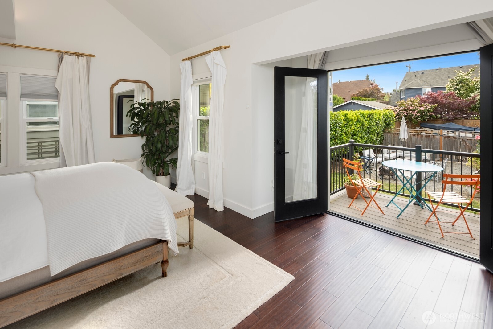 The main level primary suite is a true retreat, offering vaulted ceilings, a luxurious ensuite with double vanity, double shower, and heated floors, plus a generous walk-in closet and private deck—ideal for morning coffee or unwinding at sunset.