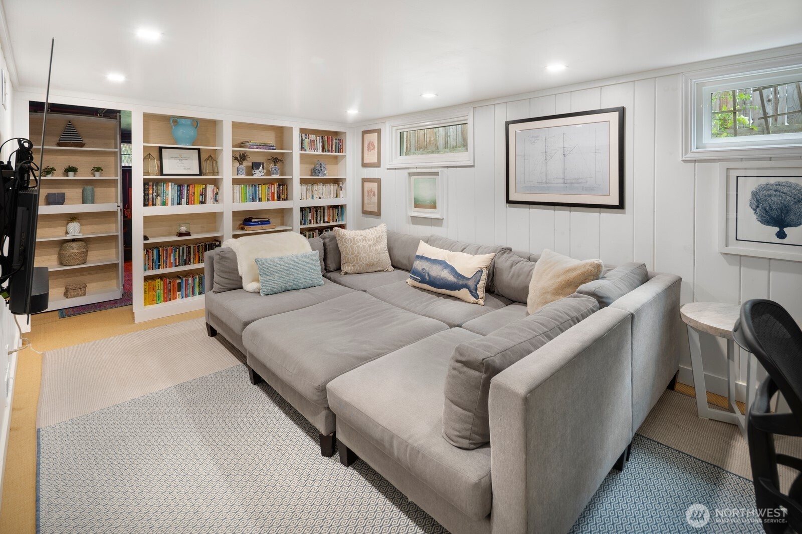 The lower level offers fantastic flexibility with a cozy media room (or optional fourth bedroom), laundry area, abundant storage, and a hidden speakeasy-style room tucked behind custom built-ins—a perfect space for entertaining or relaxing in style.