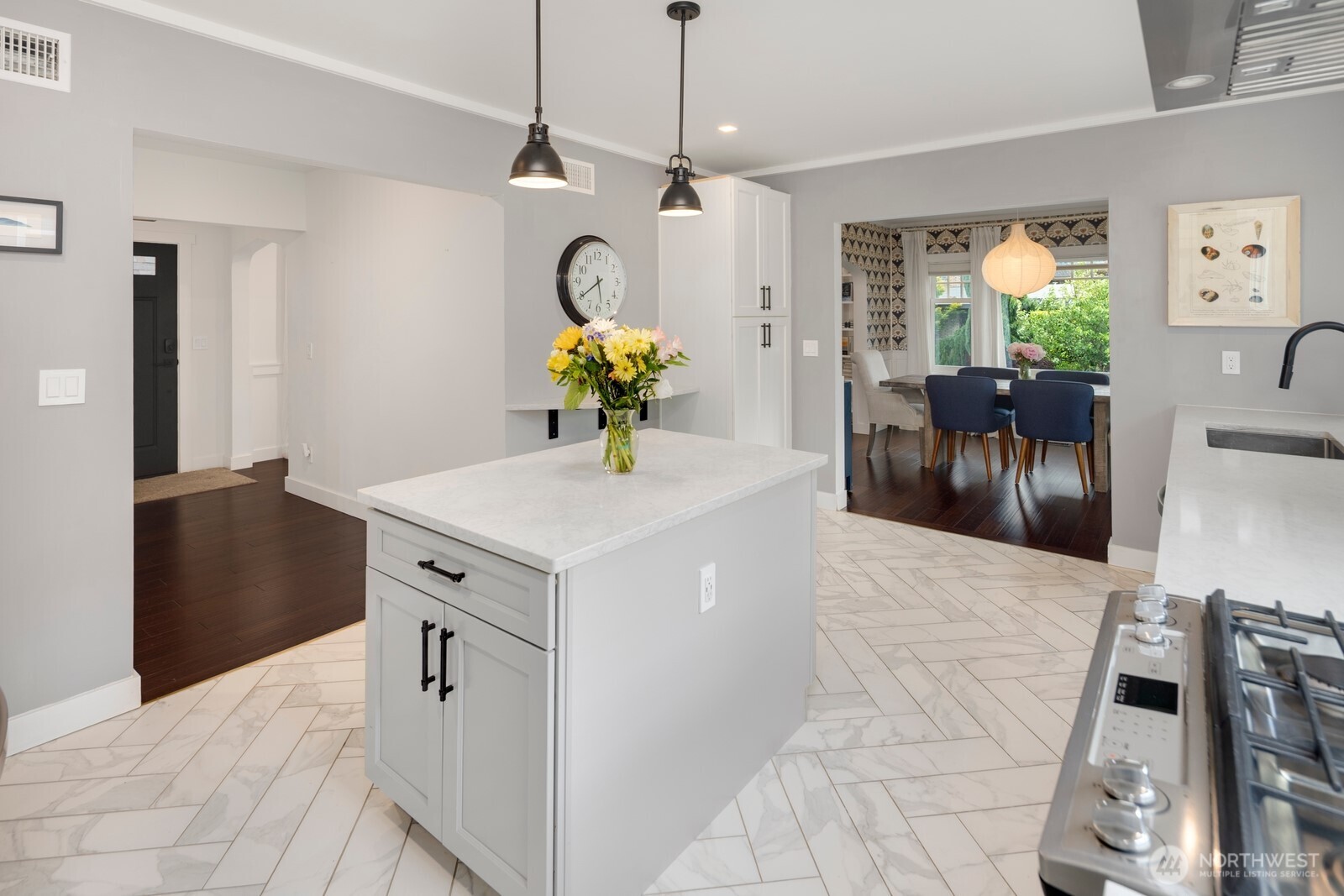 Stunning chef’s kitchen with custom shaker cabinetry, herringbone tile, and premium appliances—perfect for both everyday living and effortless entertaining.