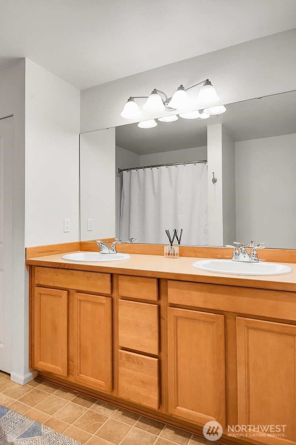 Primary en-suite bathroom. Full-sized W/D located across from bathroom in hall closet.