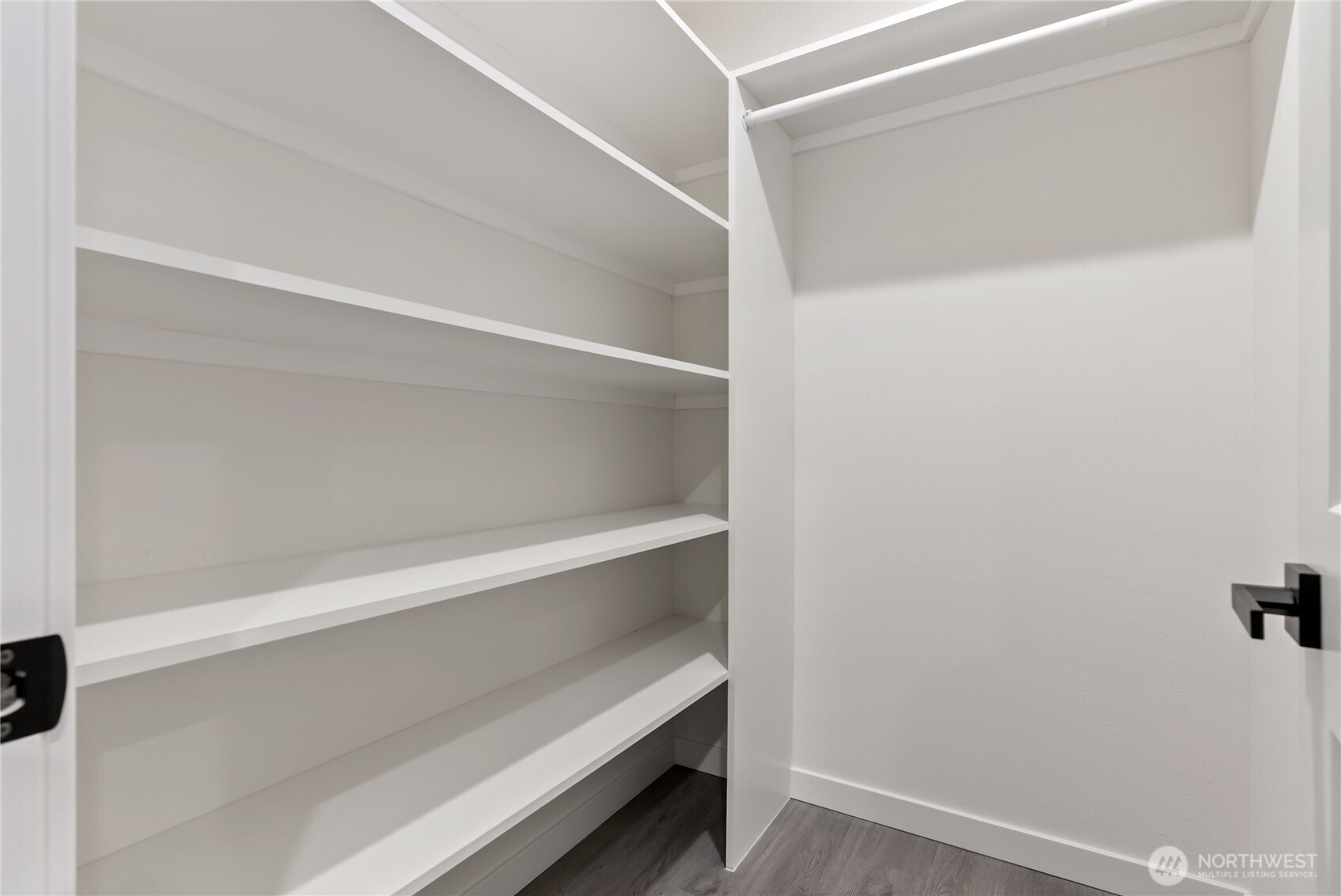 Primary bedroom closet with built-in shelves