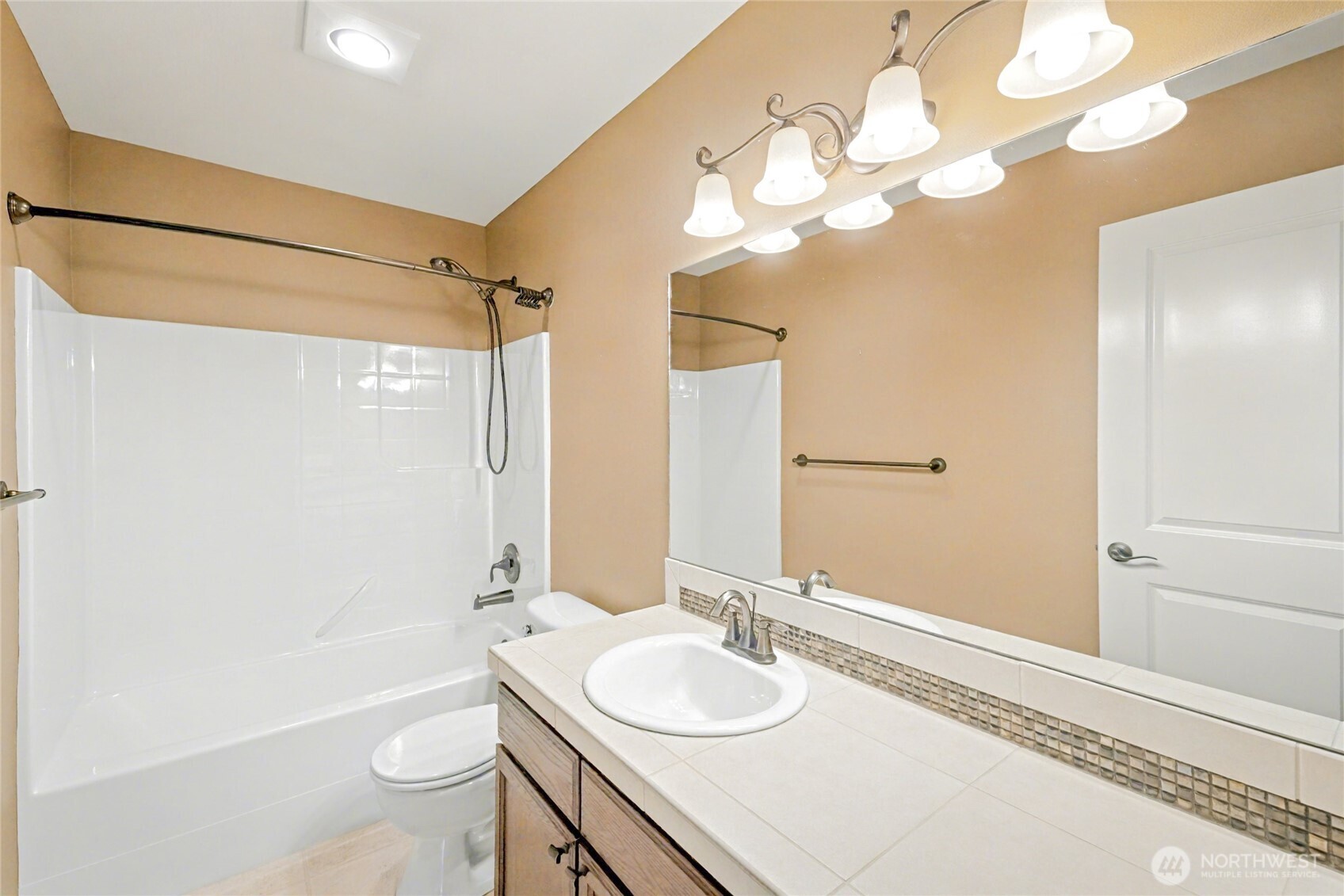 Upstairs full sized guest bathroom with ample storage and counter space.