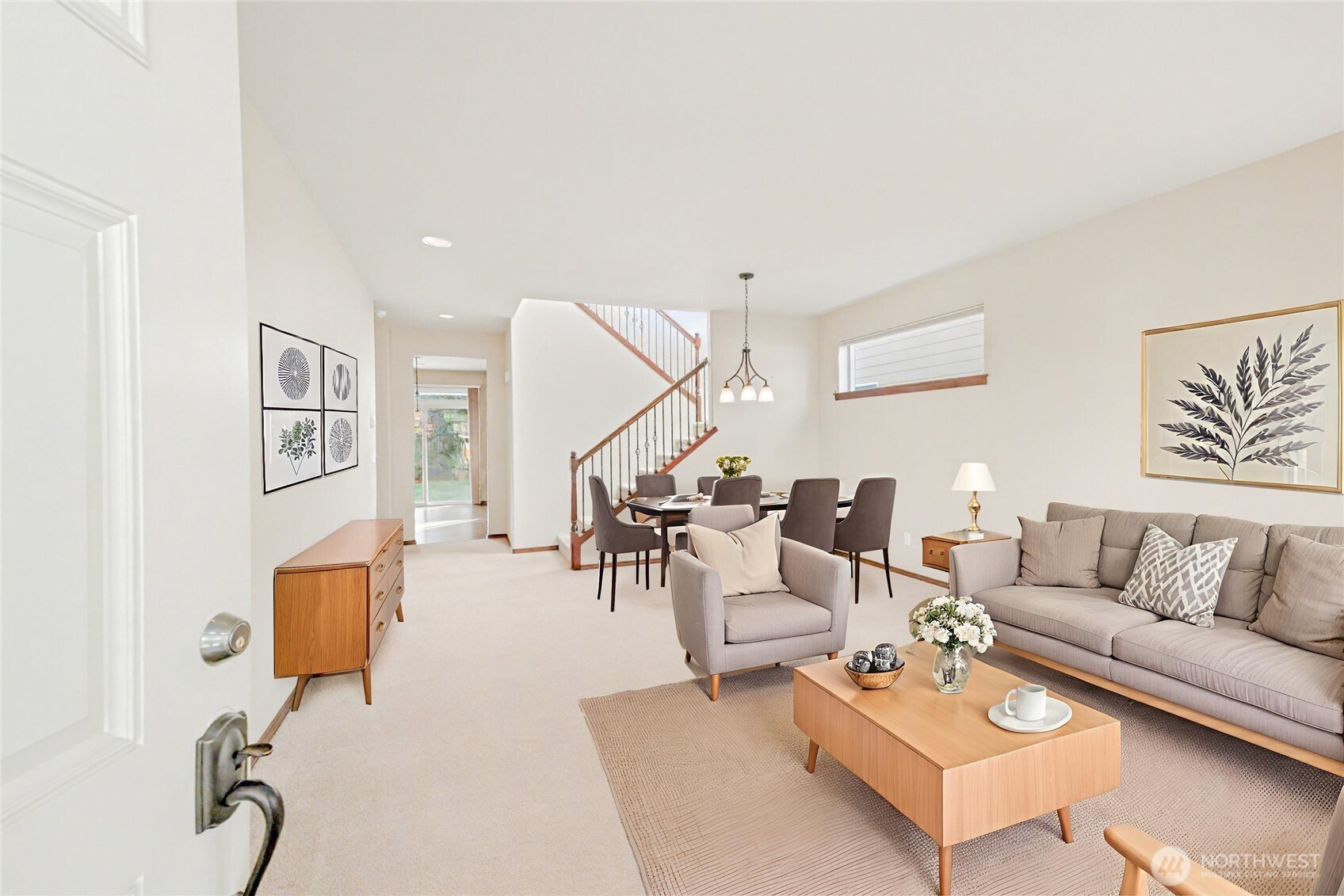 Bright and welcoming entry into the living room featuring crisp light tones and thoughtfully placed windows that bring in plenty of natural light.