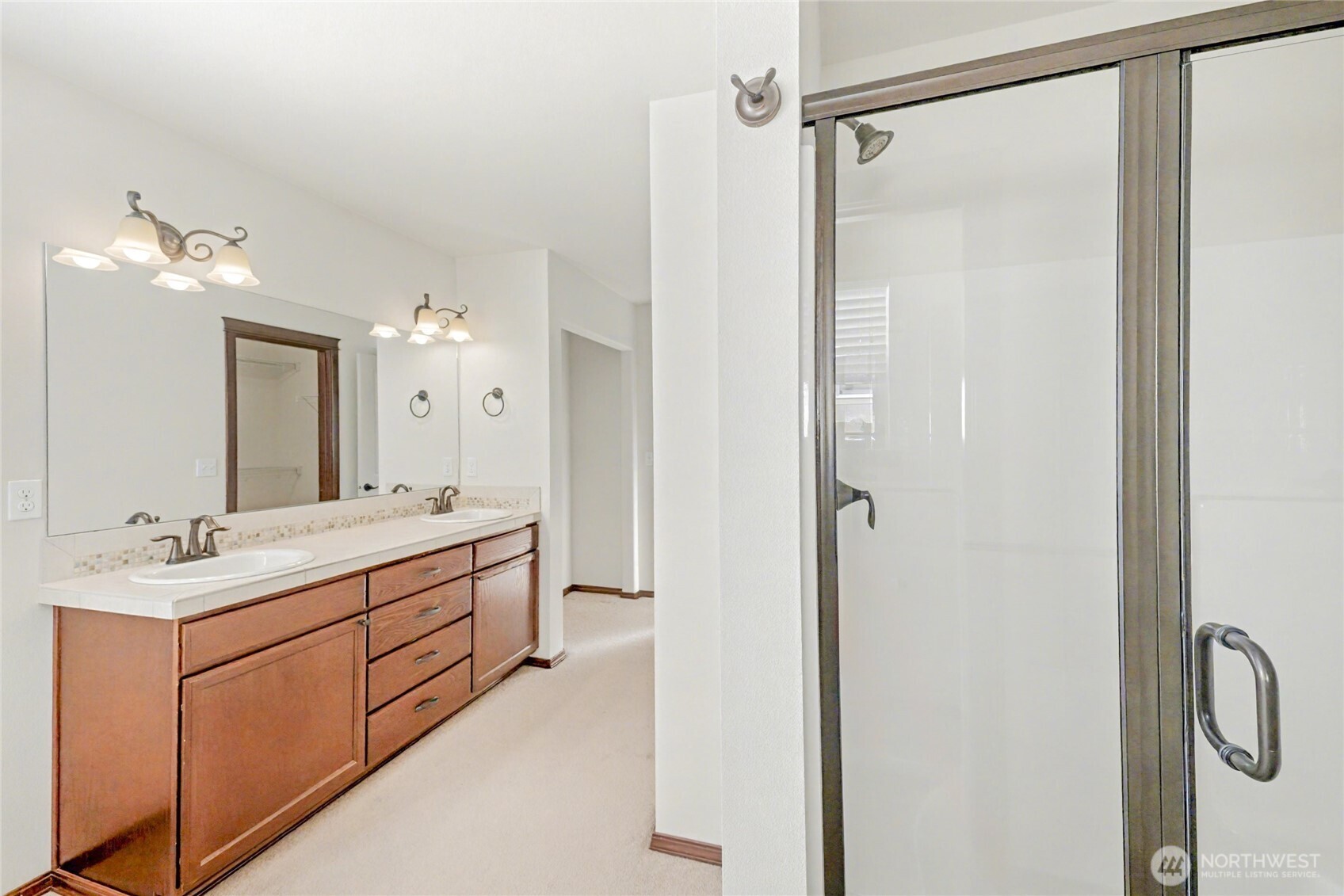 Another view of the en-suite showing the walk-in shower and distance view of the closet, with the sizeable walk-in closet another the corner.