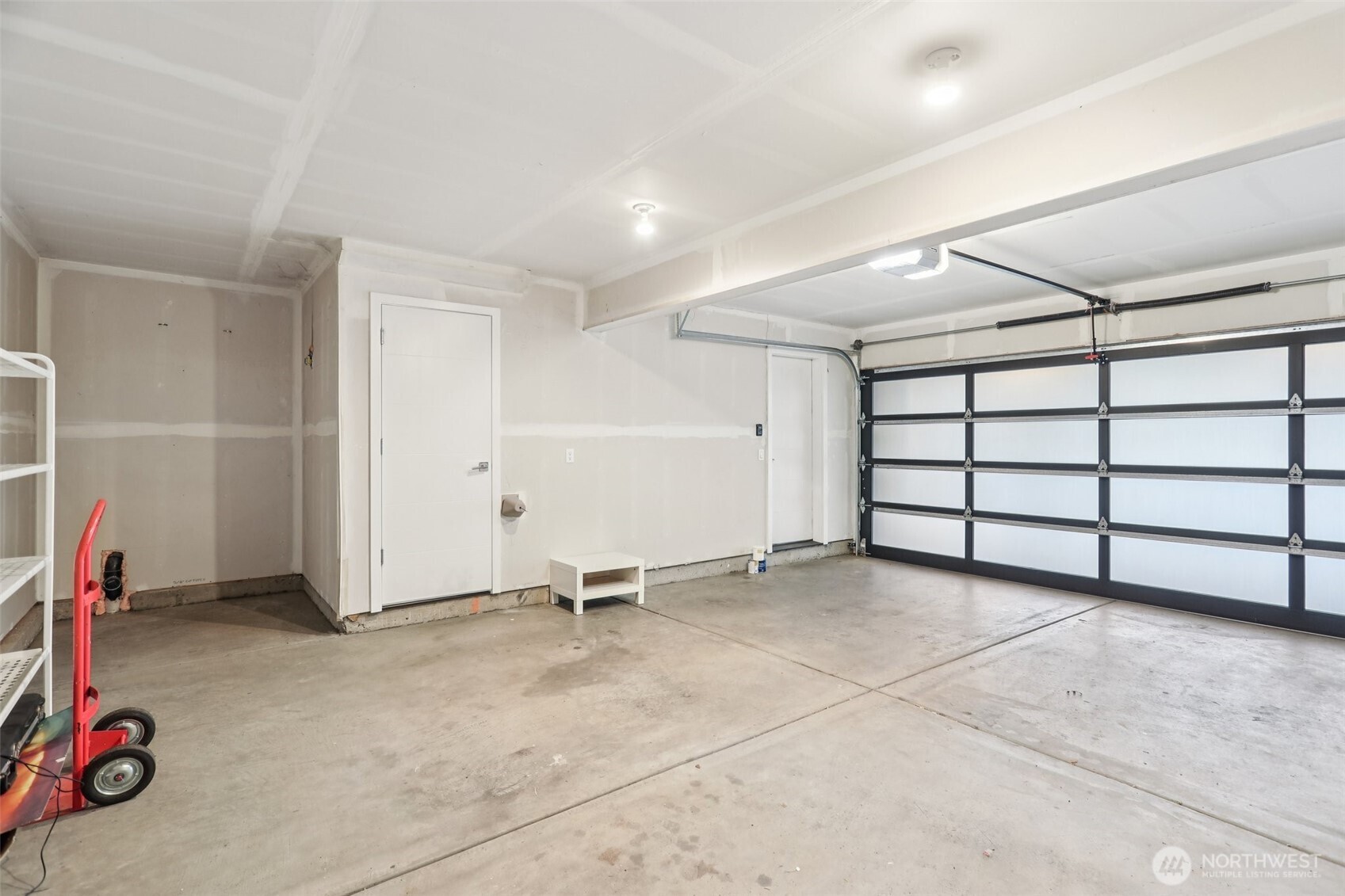 Spacious 2 car garage with additional storage closet and storage nooks
