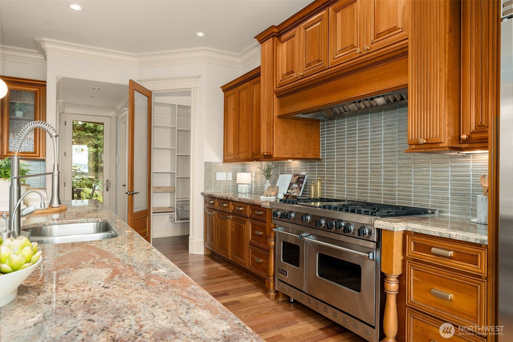 Inviting patio with basalt stone water feature.  There is an abundance of square footage to allow for container gardening in full sunshine along the walkway. Or renovate into plentiful playspace for kids and pups!