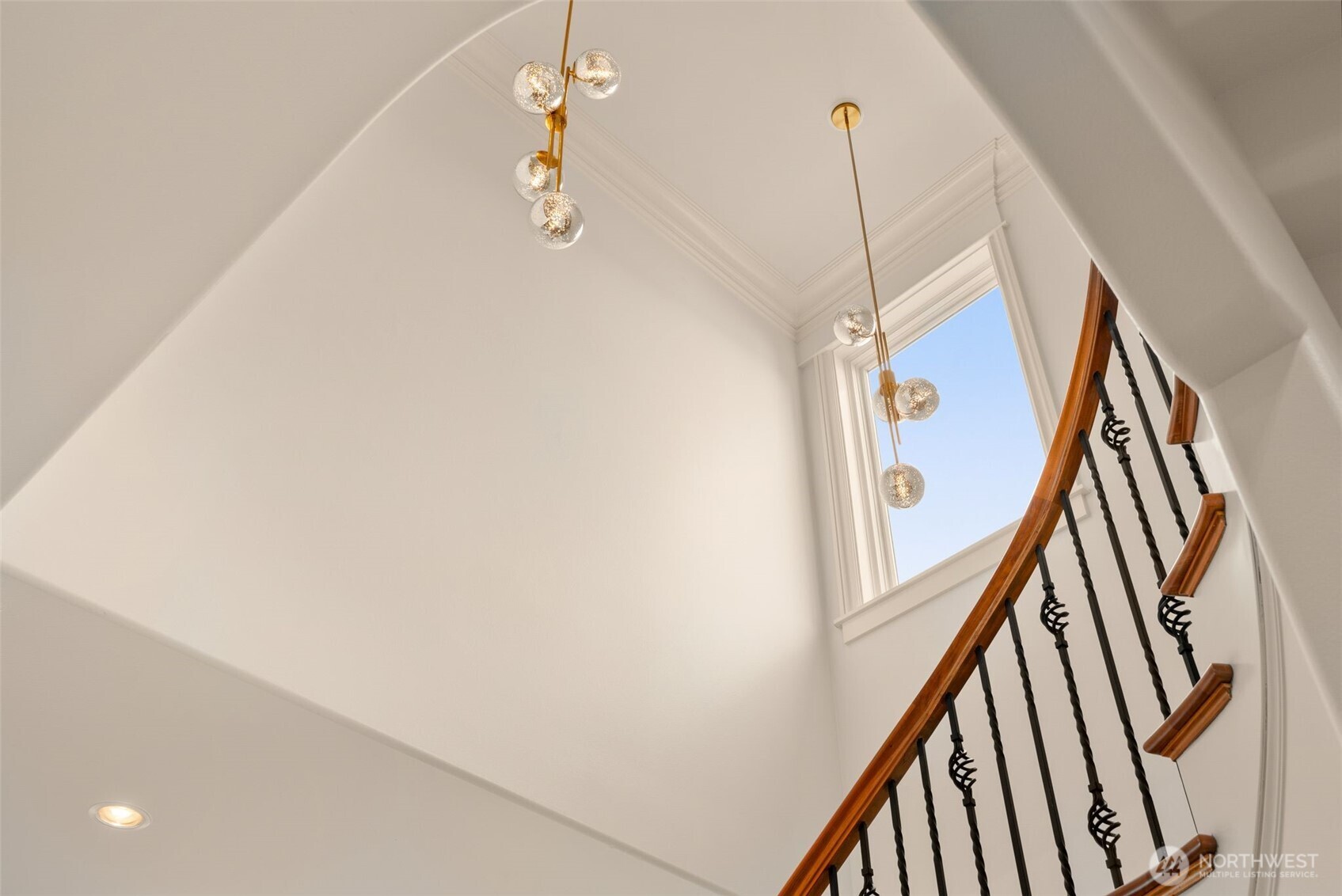 Artsy photograph of new lighting in dramatic stairwell.  Room to hang some impressive art pieces.