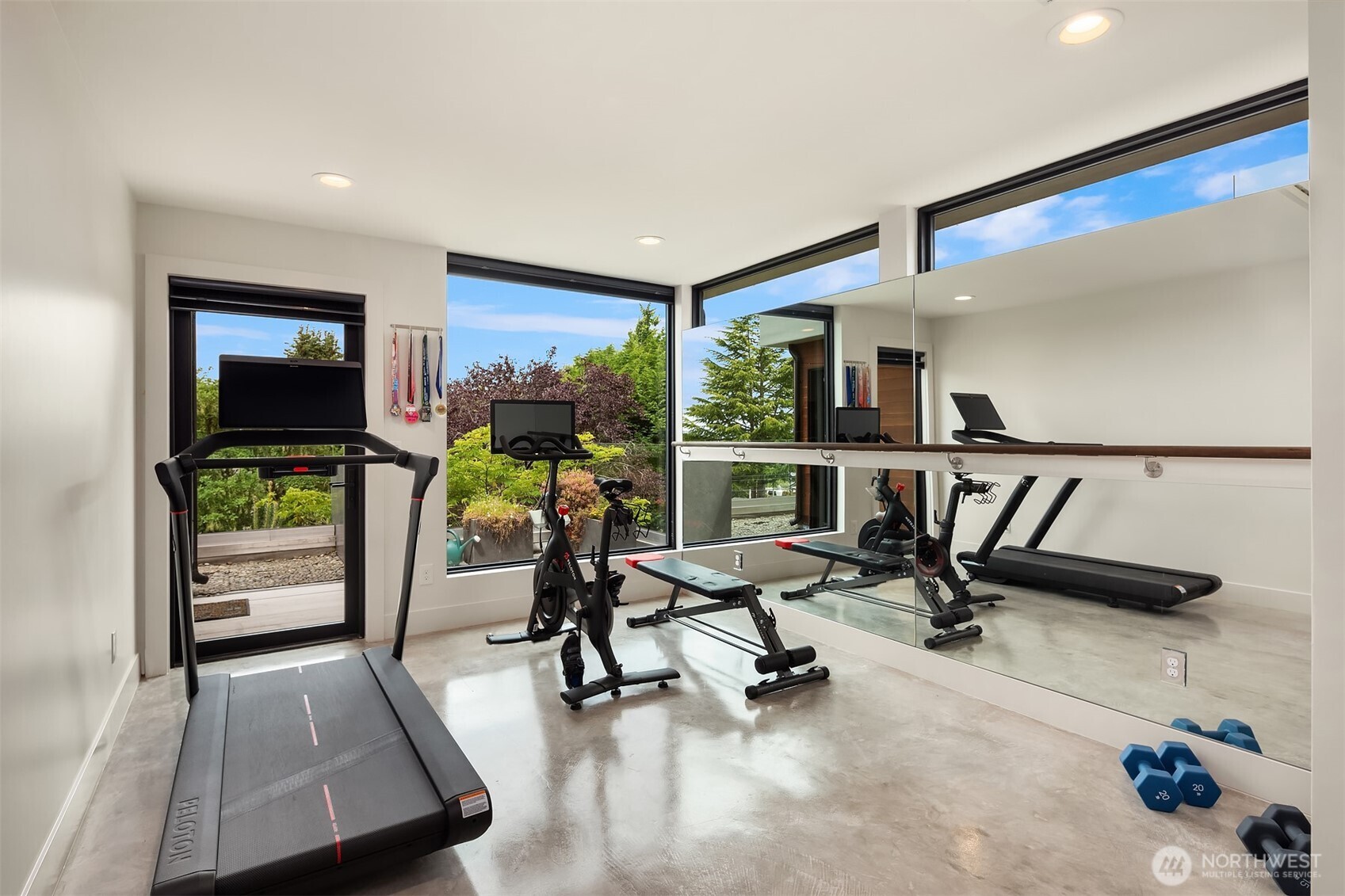 Sunlit bedroom or home gym with patio access