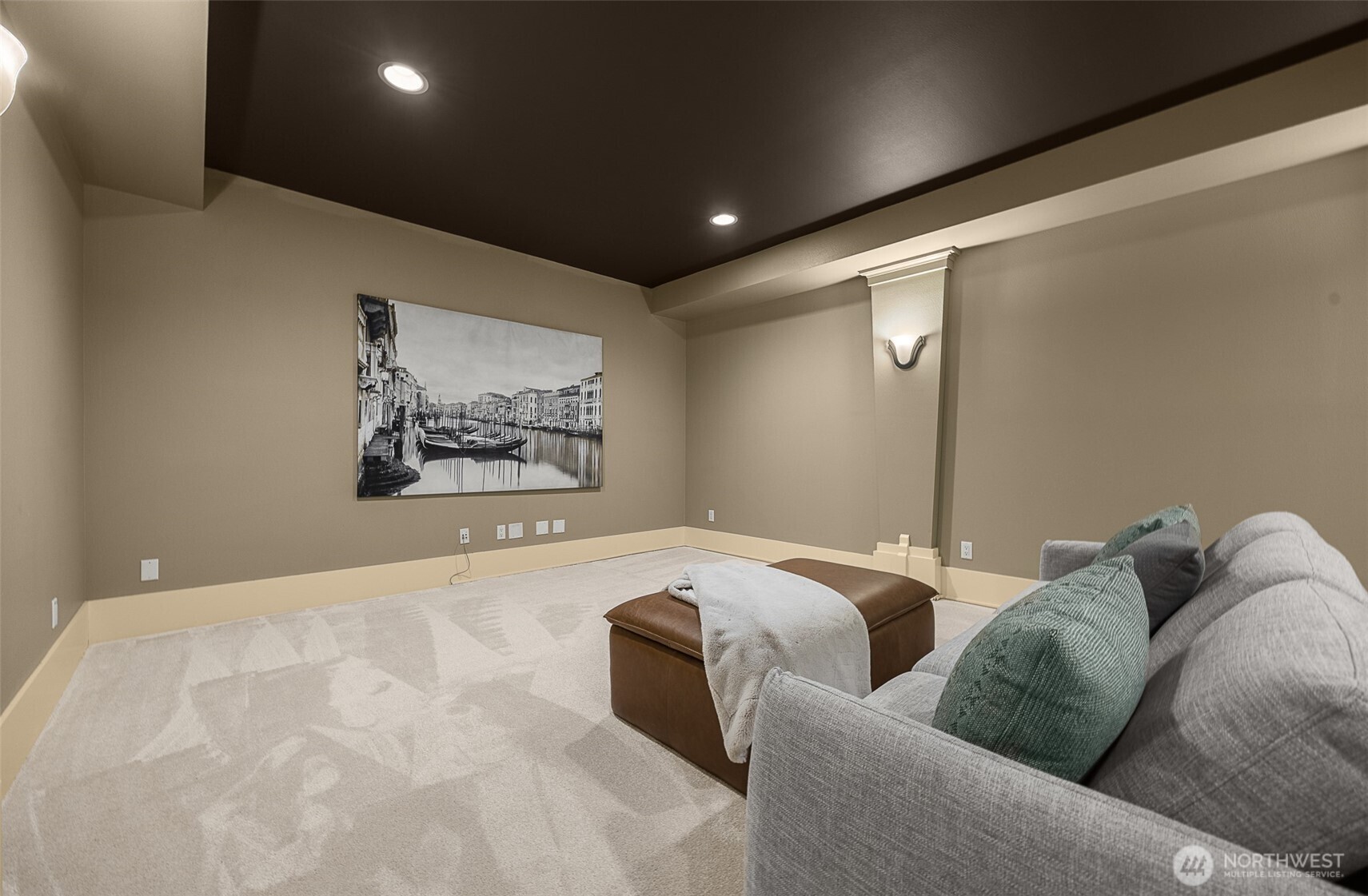 A separate private open theater or game room on the lower level