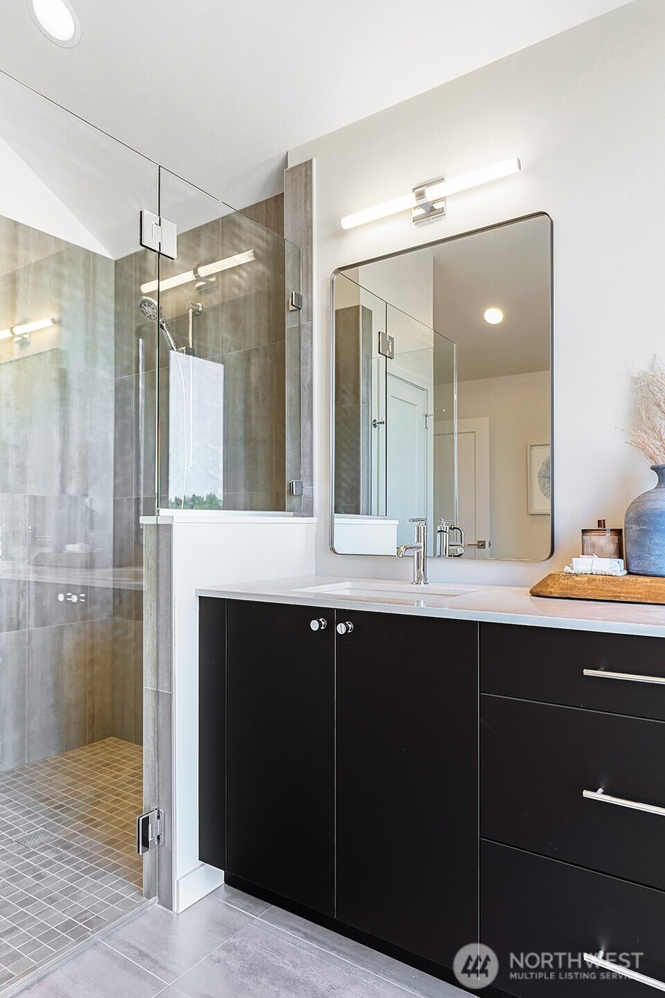Photos of model home 9752 with similar finishes & floor plan. Another look at the shower and vanity setup—simple, modern, and thoughtfully styled.
