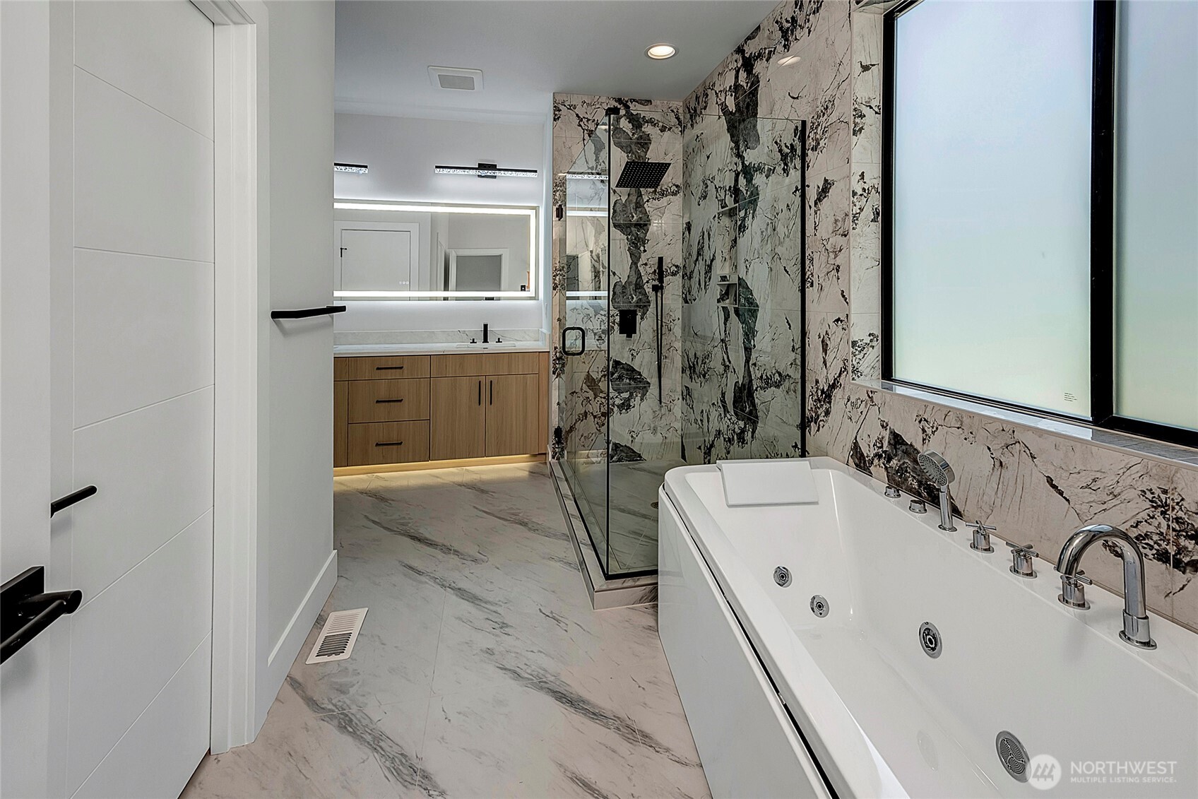 Big and luxurious primary bathroom, full tub and glass shower (virtually staged, photo of similar home in separate community)