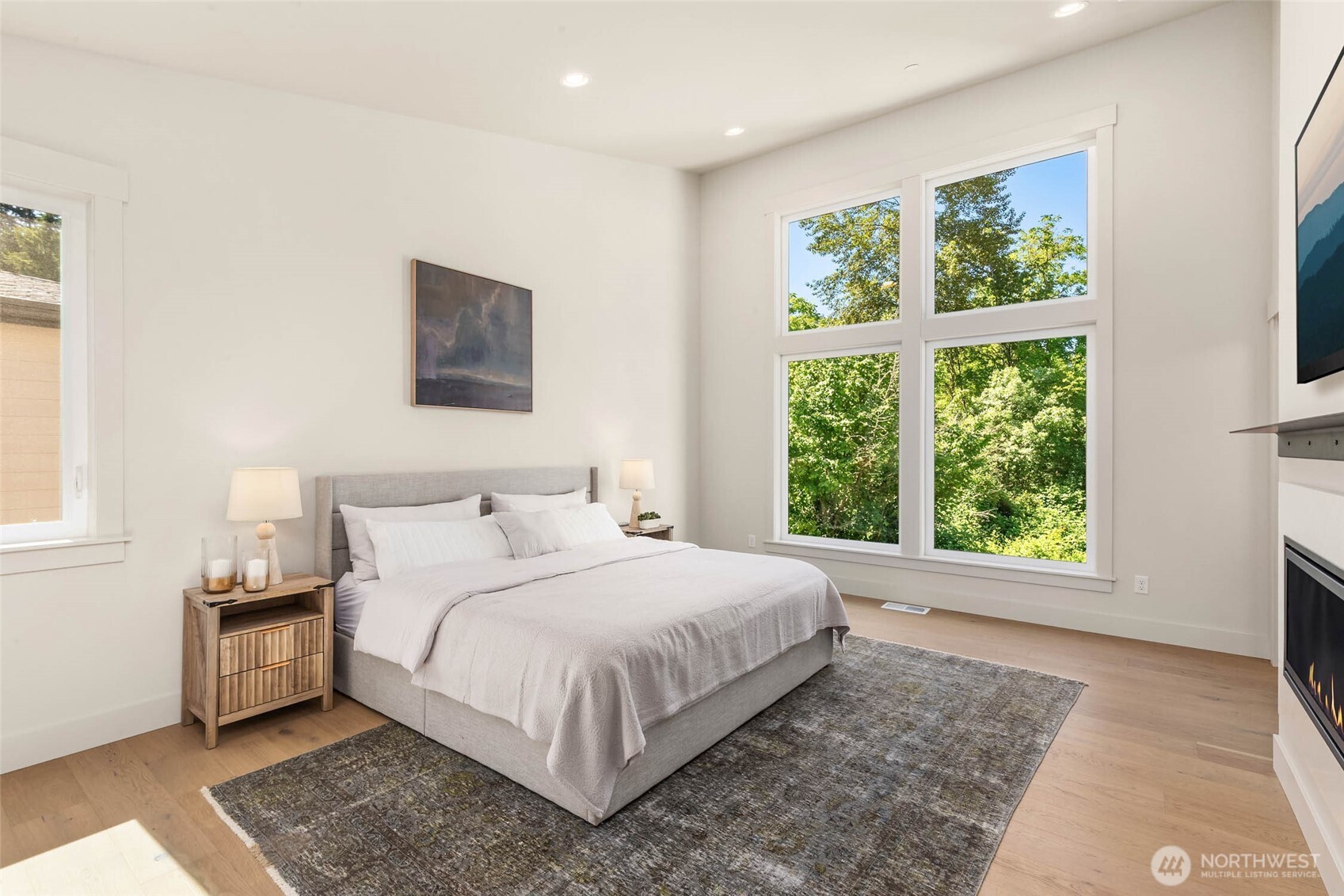 Stunning Primary Suite with vaulted ceiling with window wall overlooking protected green space beyond