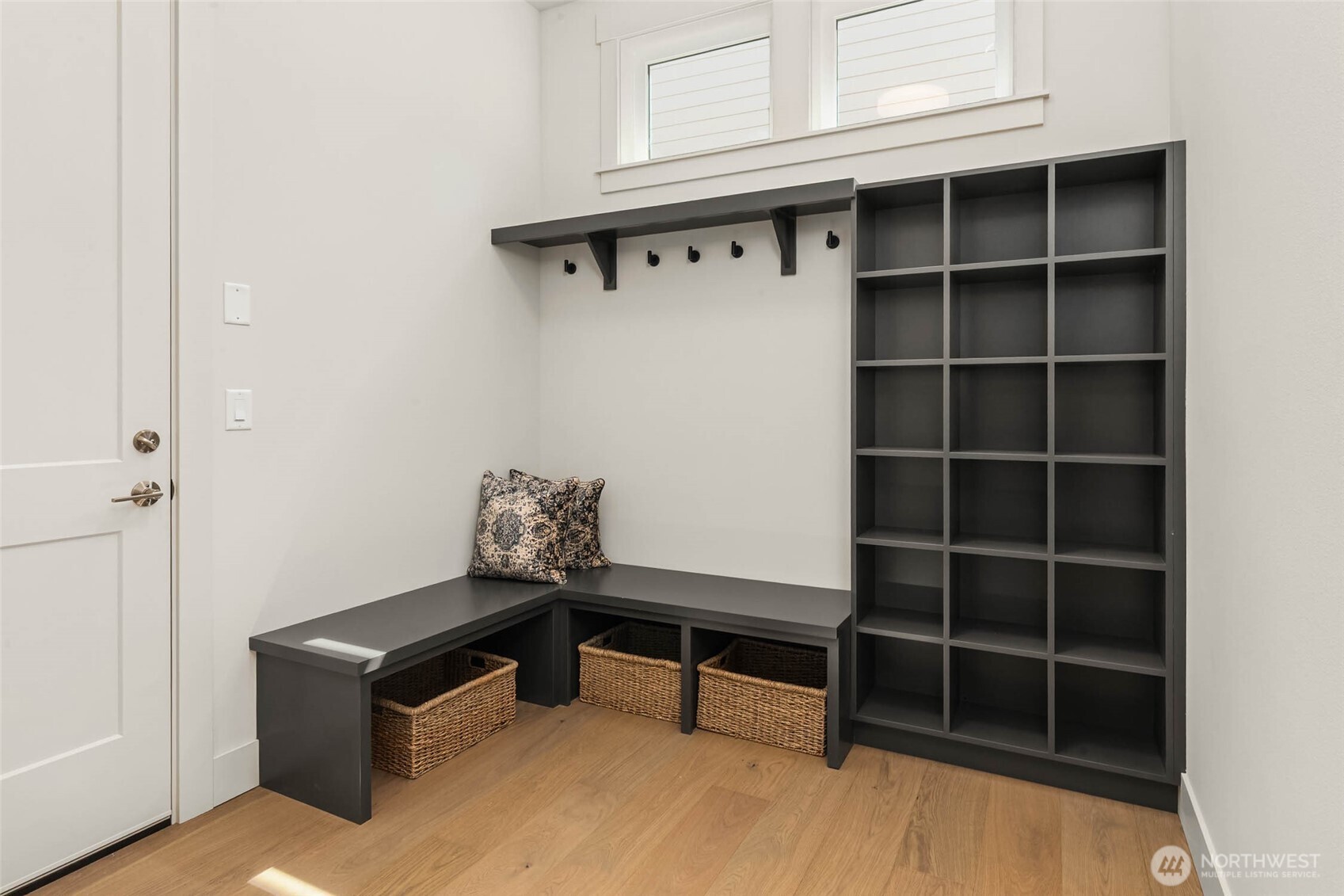 Mudroom off garage with custom built benches, cubbies, and coat hangers