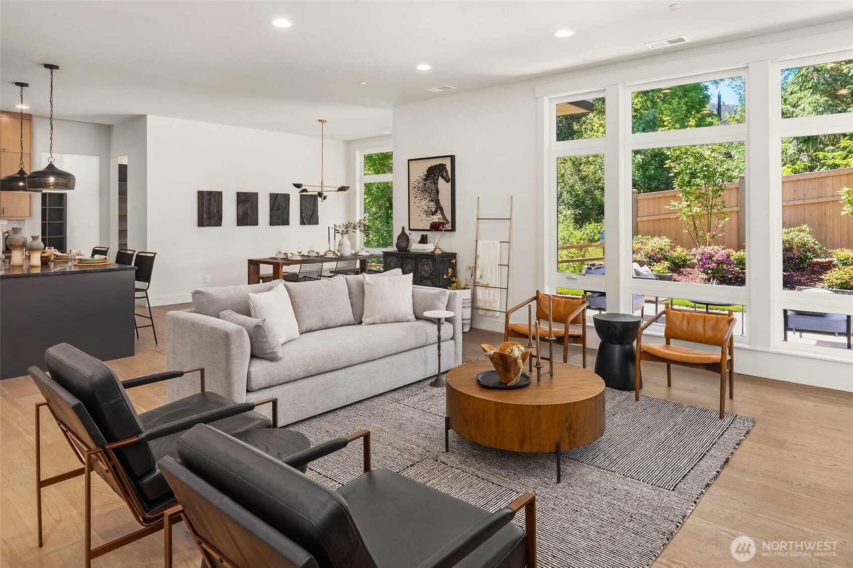 Main floor living spaces flooded with natural light through floor to ceiling window walls and 10 foot ceiling height