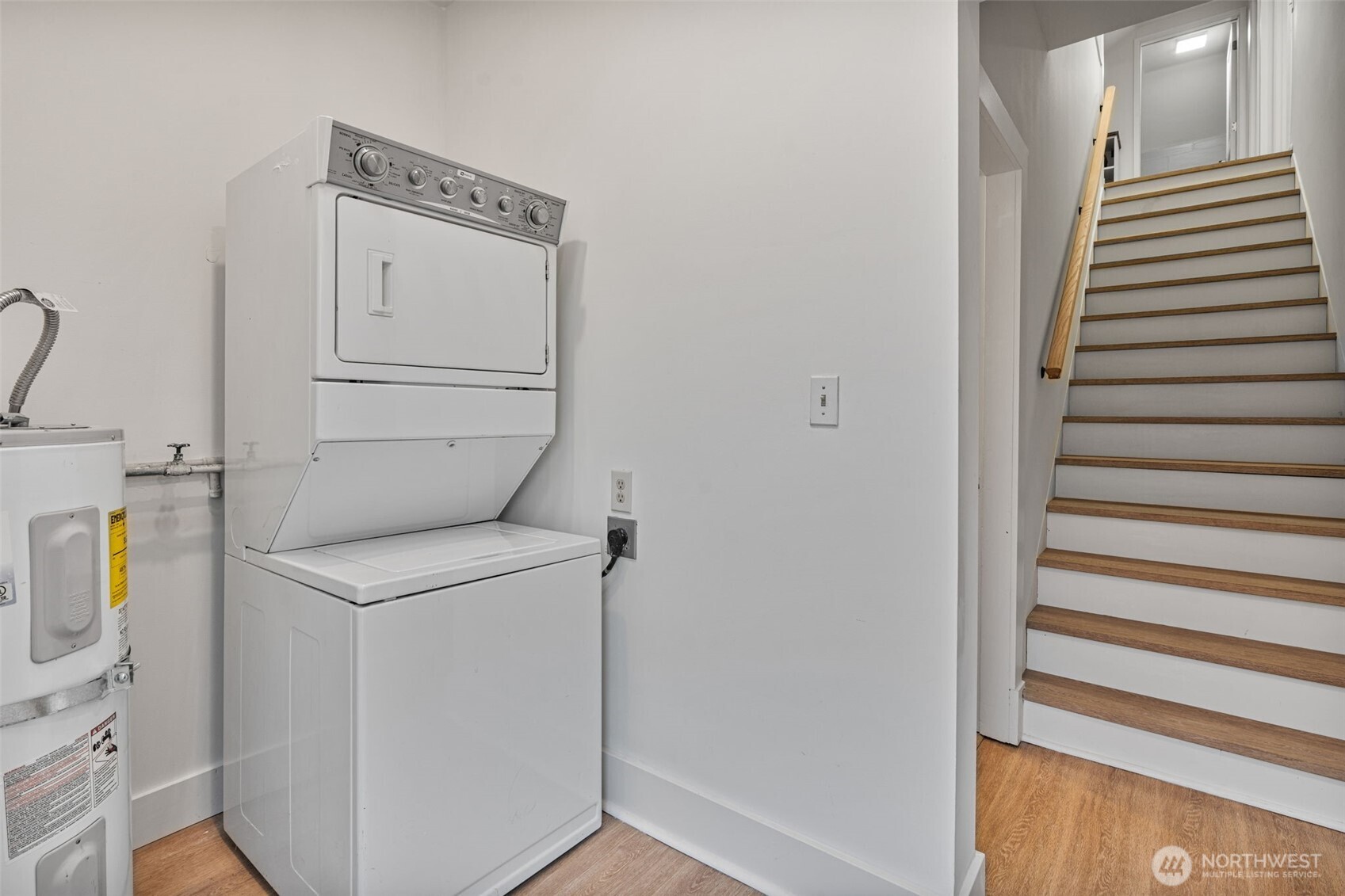 Main-floor utility/laundry room with exterior door to the backyard.