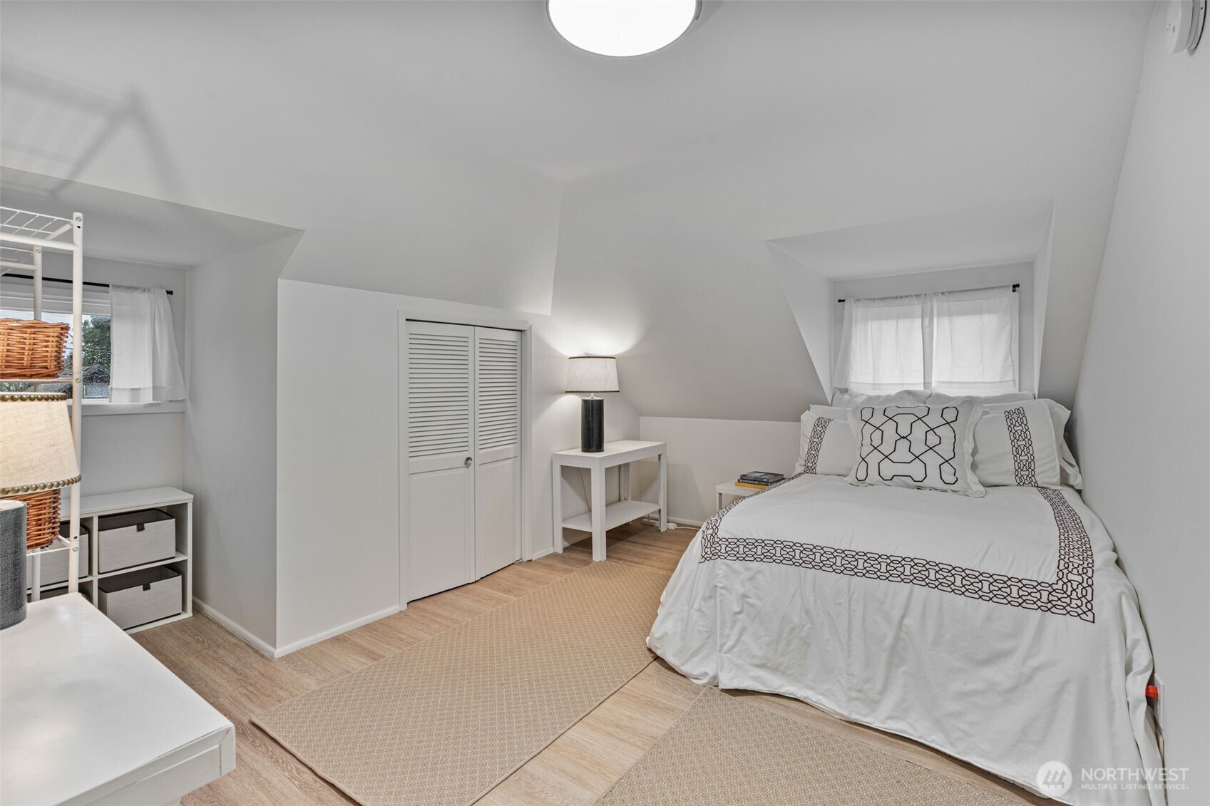 Bright, roomy bedroom that fits a queen bed with ease.