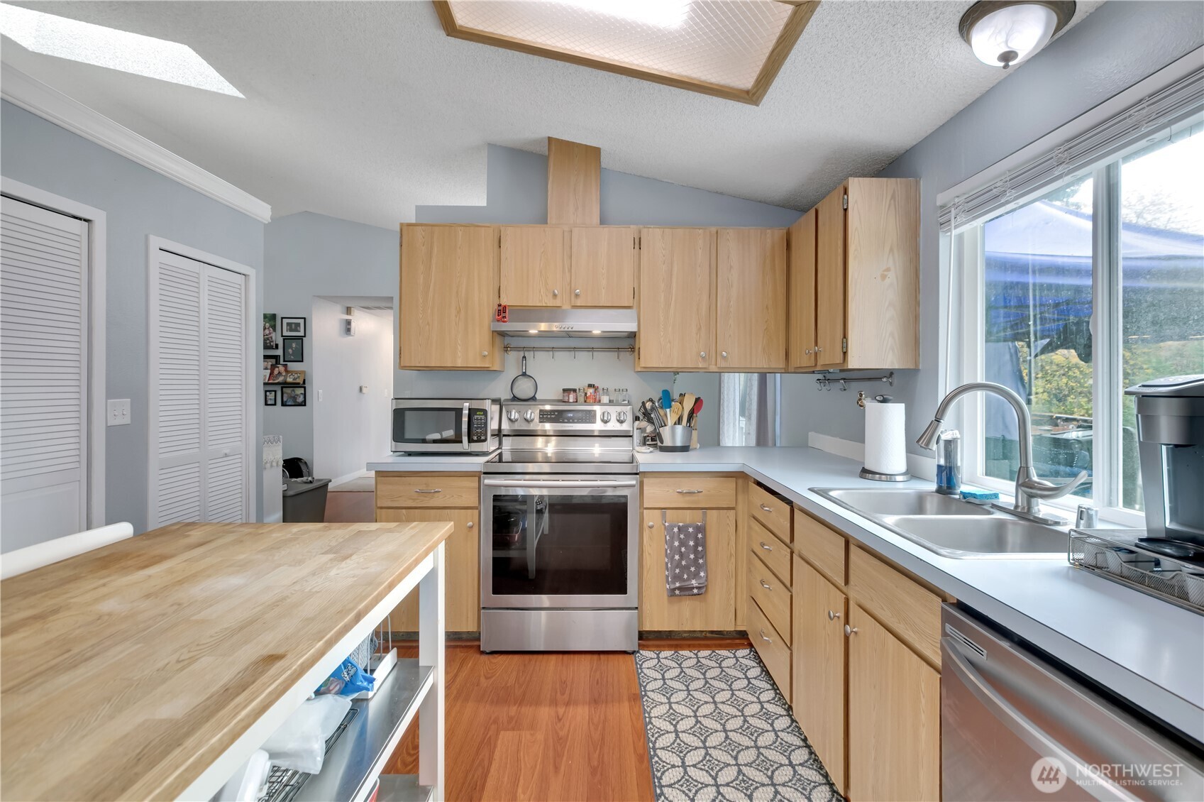Kitchen has a pass-through window for easy service to the dining room from the oven (to the right of the oven in the photo).