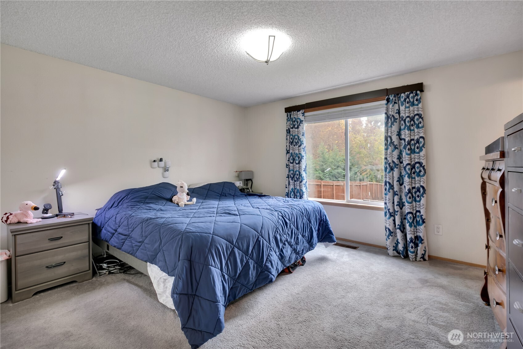 Spacious master bedroom with a nice, large window. You won't get tired of the view of your backyard!