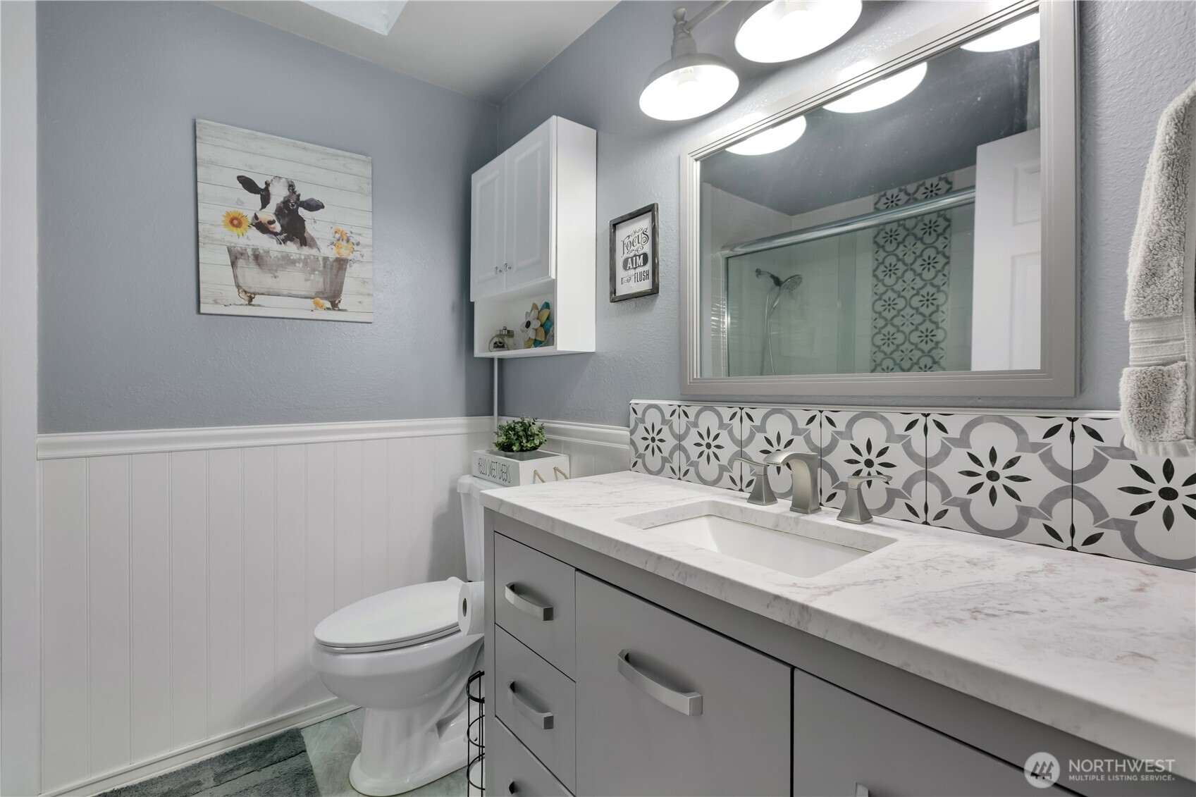 Spare/guest bath is updated with lots of beautiful tile detail.